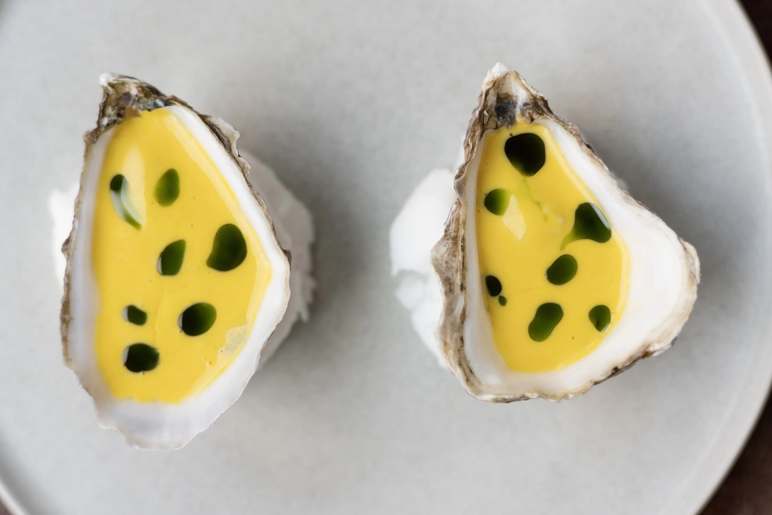 Close-up of two halves of a oysters, Peruvian style.