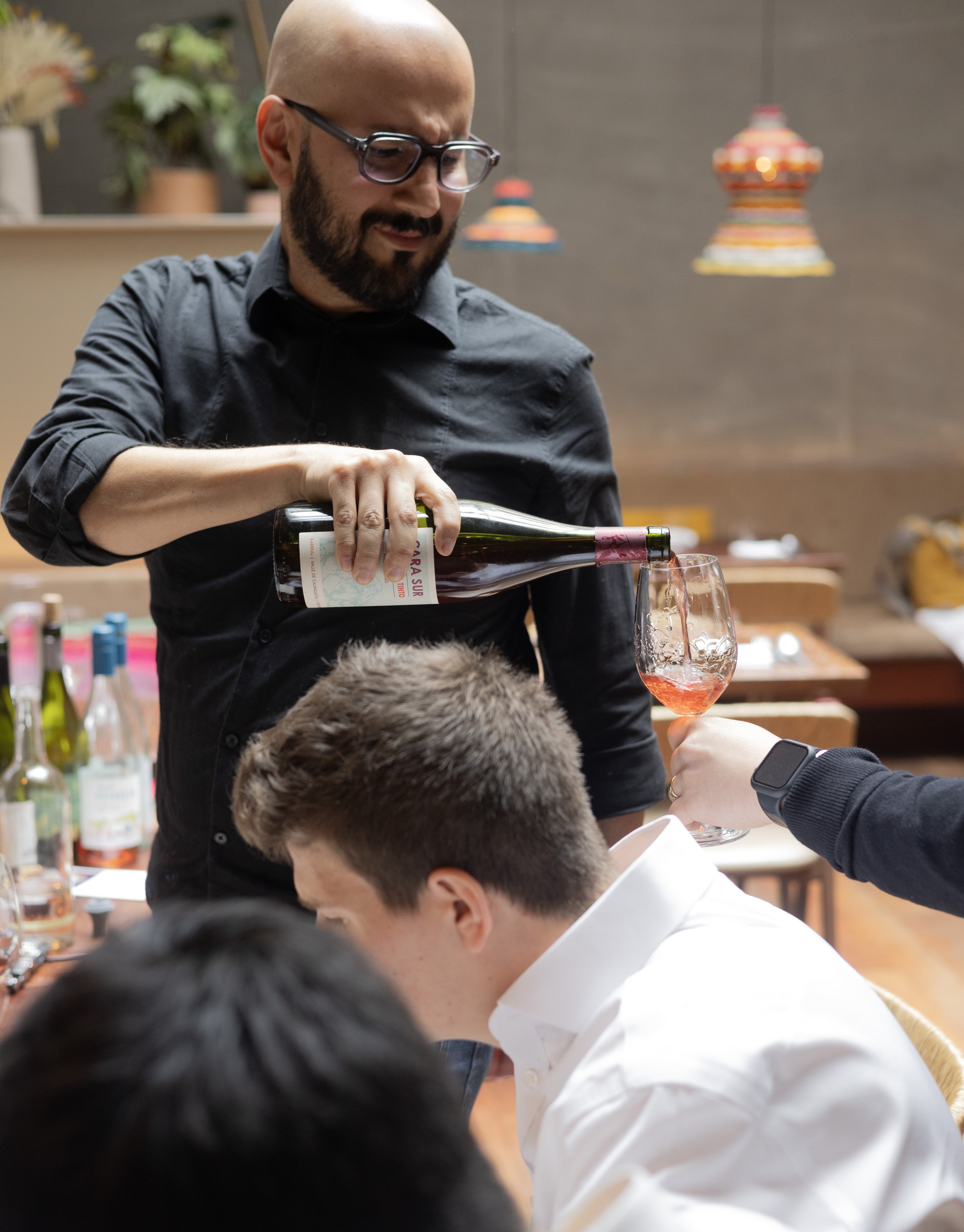 Natural wine tasting, preparing our new wine list, at LIMA Fitzrovia, with other bottles in the background.