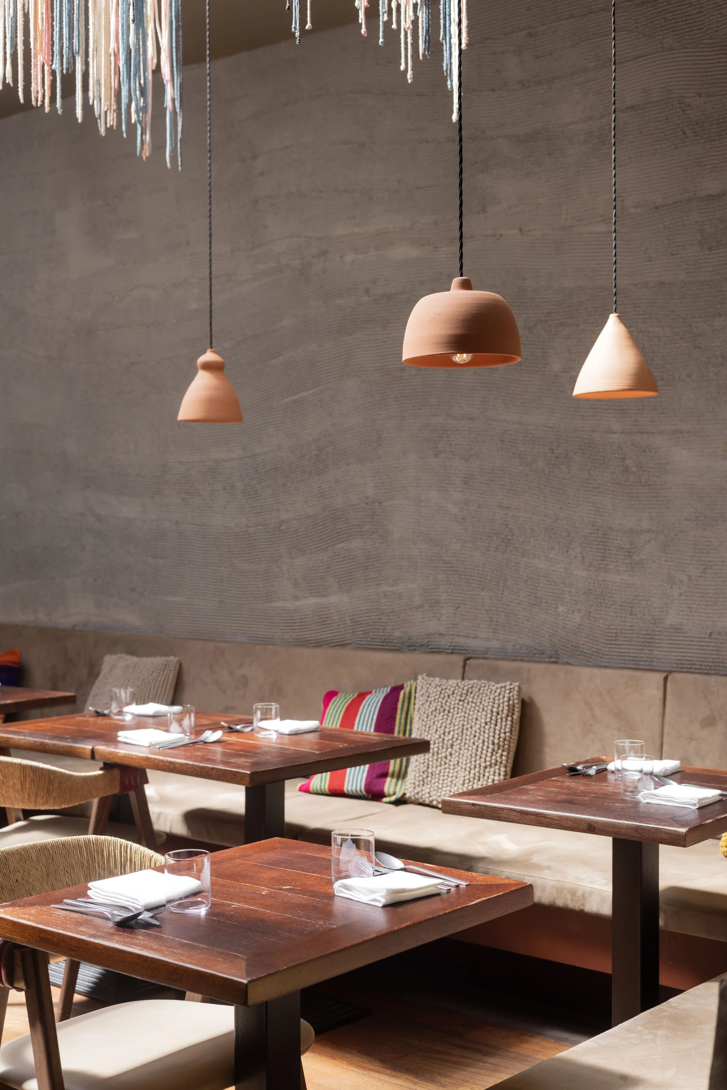 Dining Room at Lima Fitzrovia. with wooden tables set with napkins, glasses. Warm, cosy and bright, perfect for a private dining experience. -