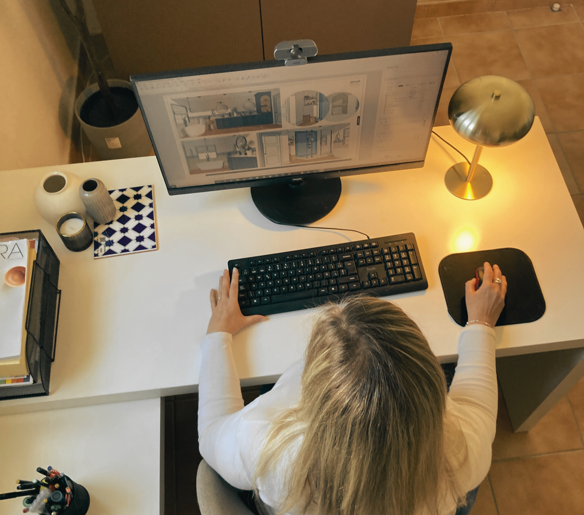 Interior designer developing residential design documentation and project drawings at a professional workspace.