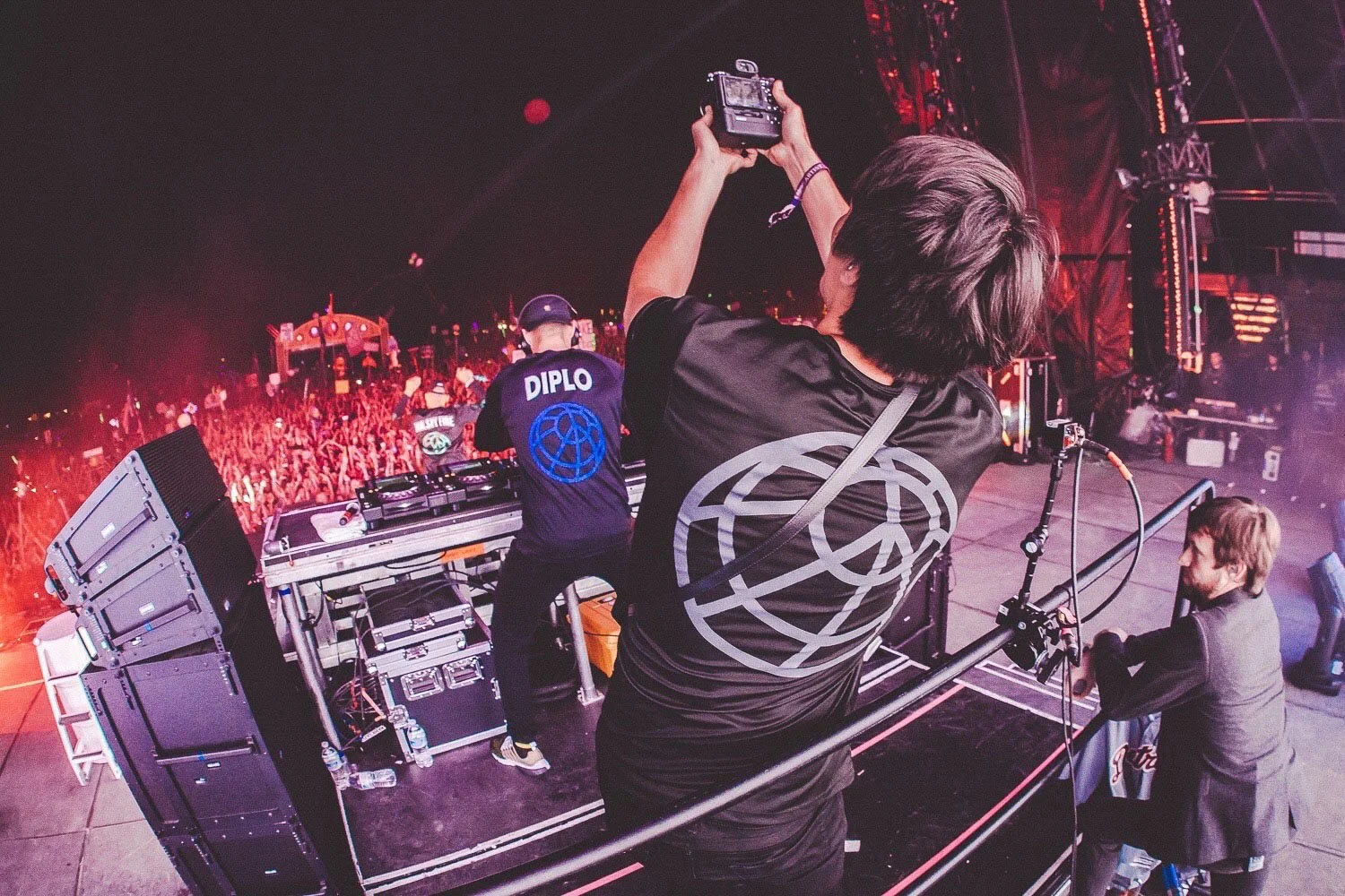  Camera operator filming a live concert from the stage. 