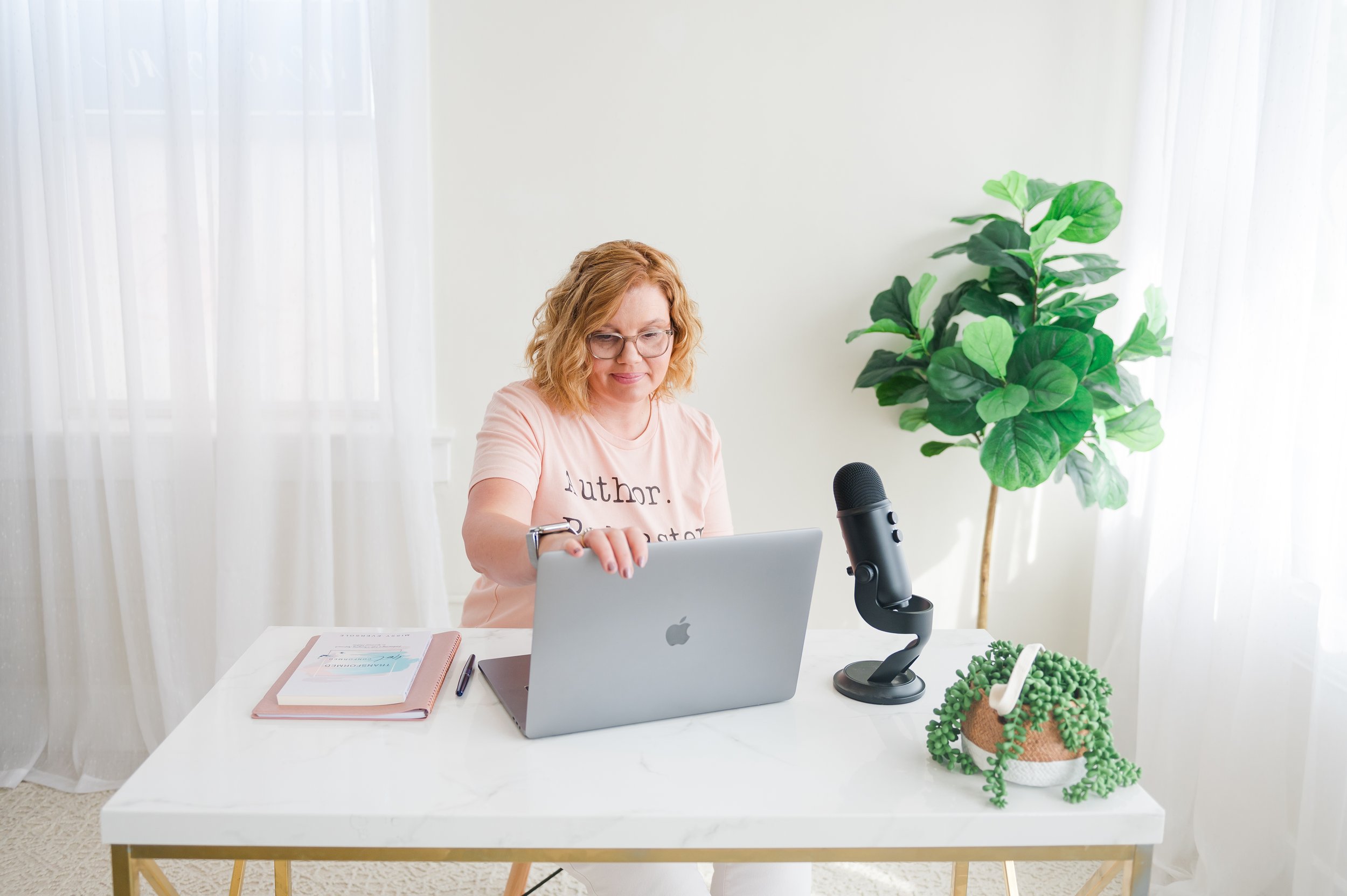 author sitting at computer typing