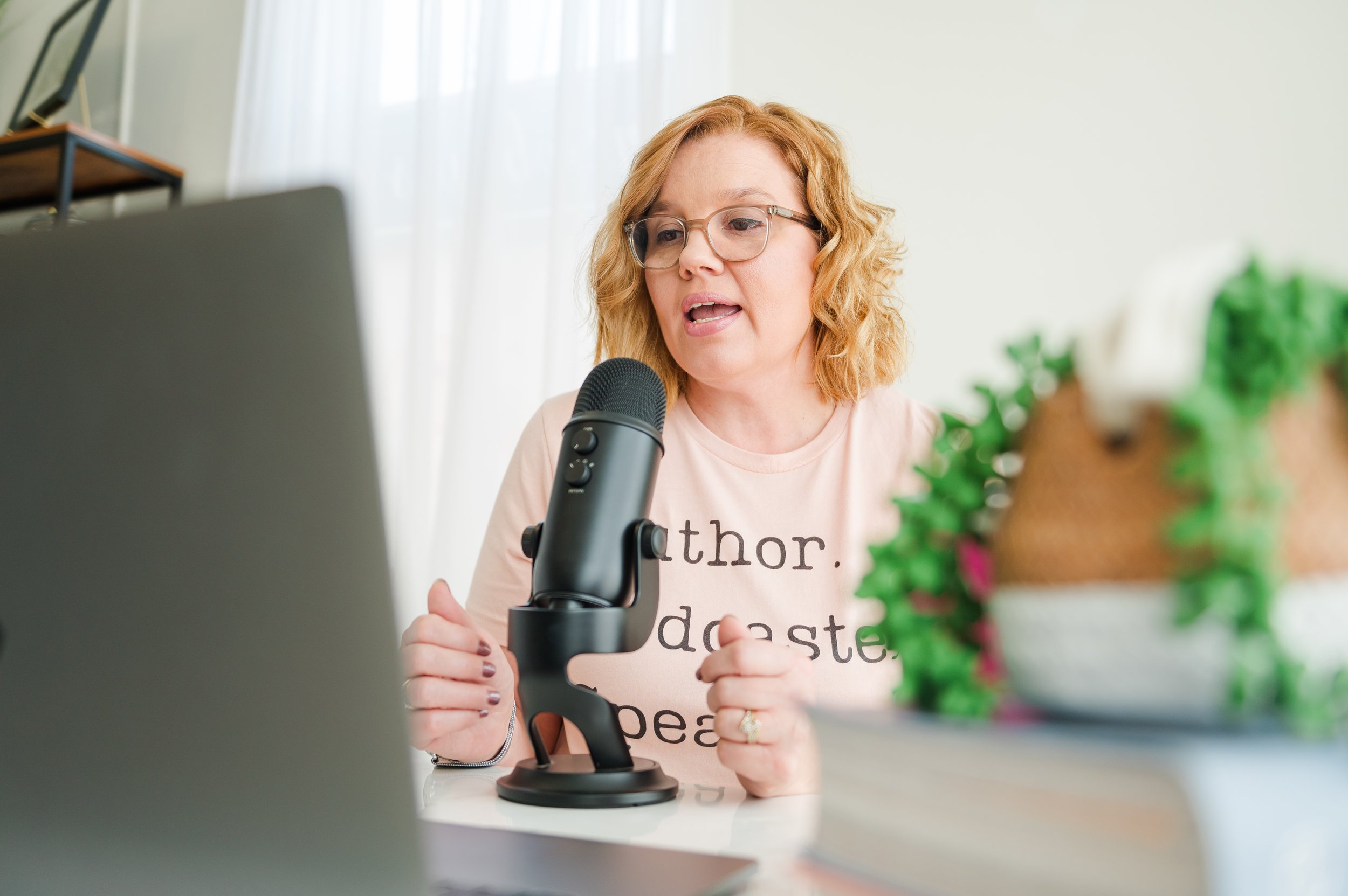 author and podcaster sitting at desk recording 