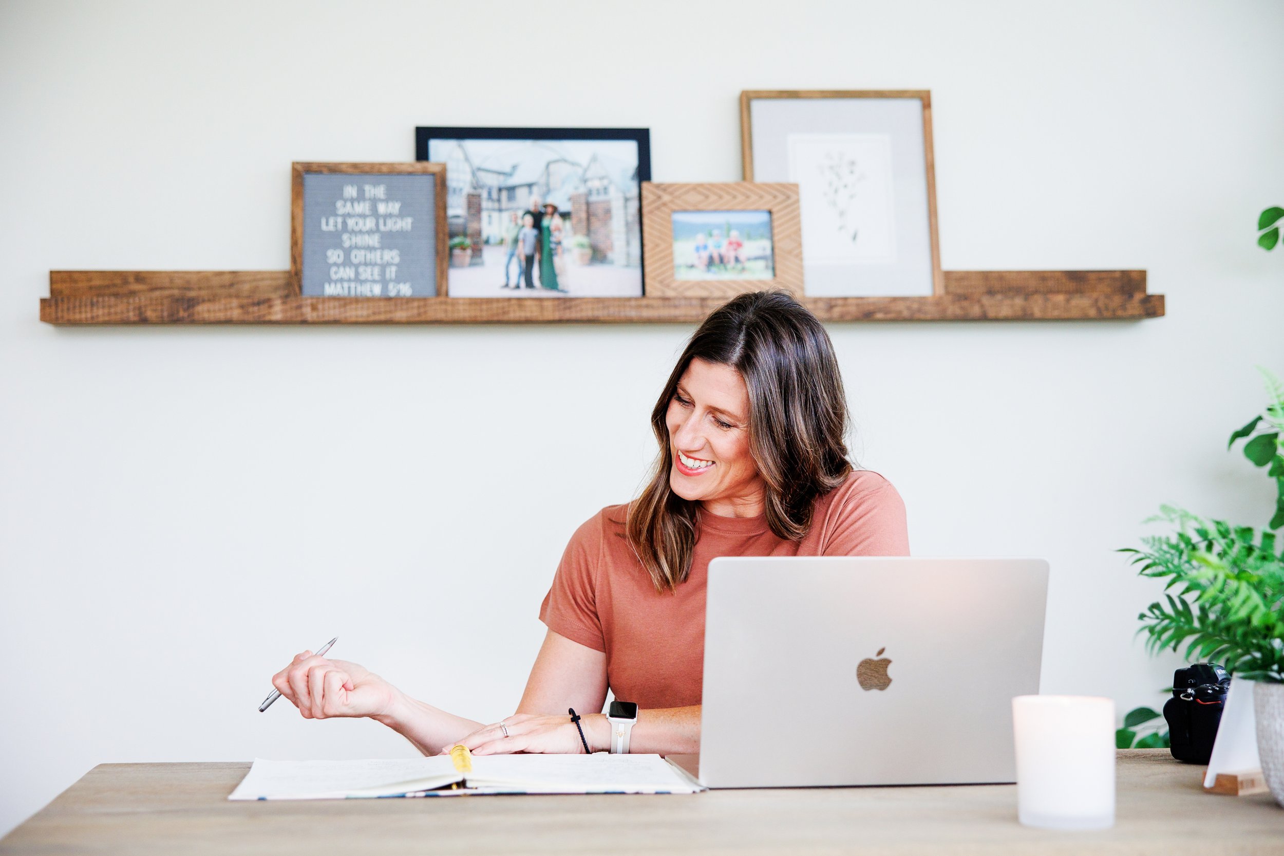 Bloomington IL Personal Brand Photographer seated at desk writing on notepad