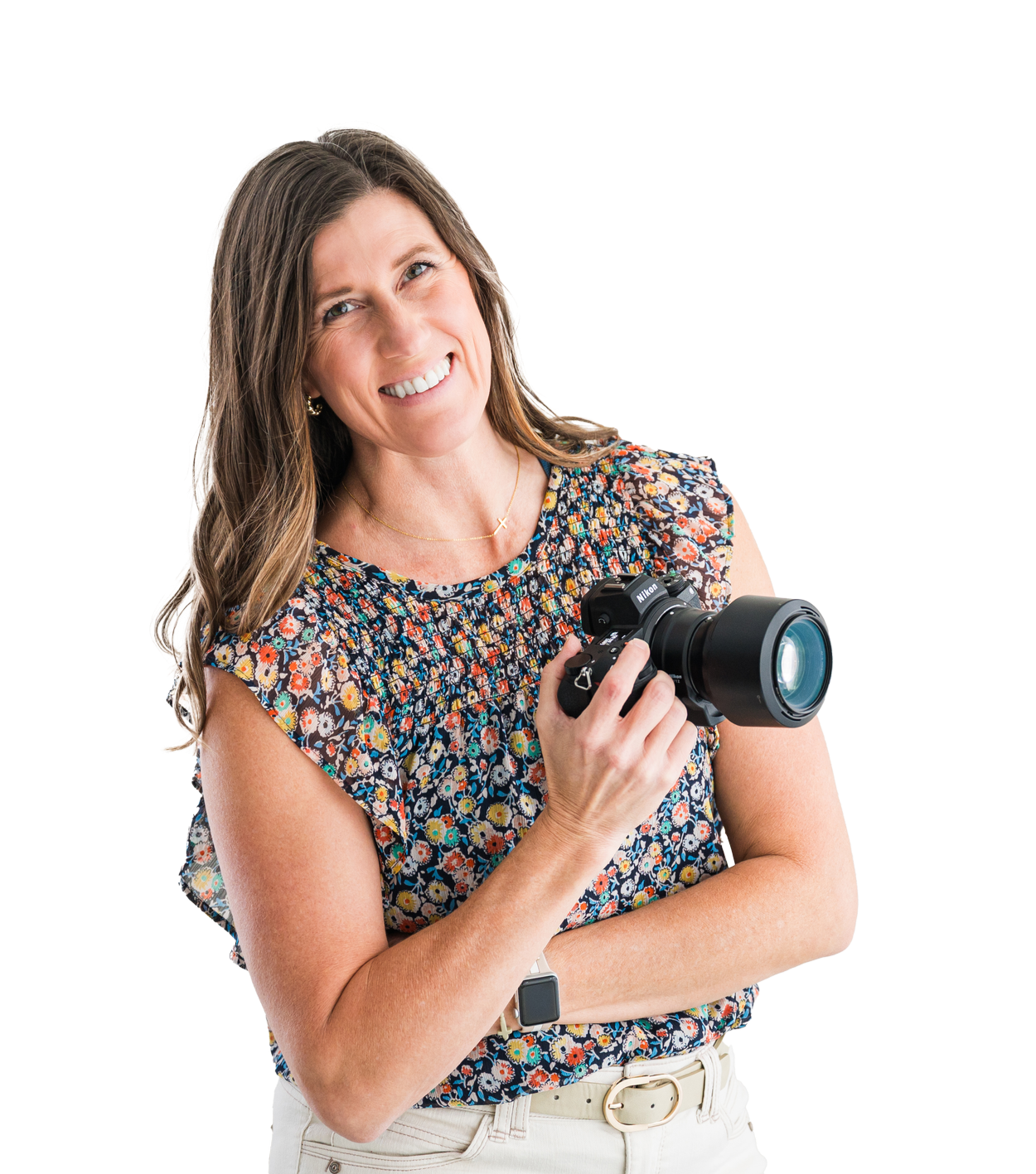 A woman smiling and holding a camera.