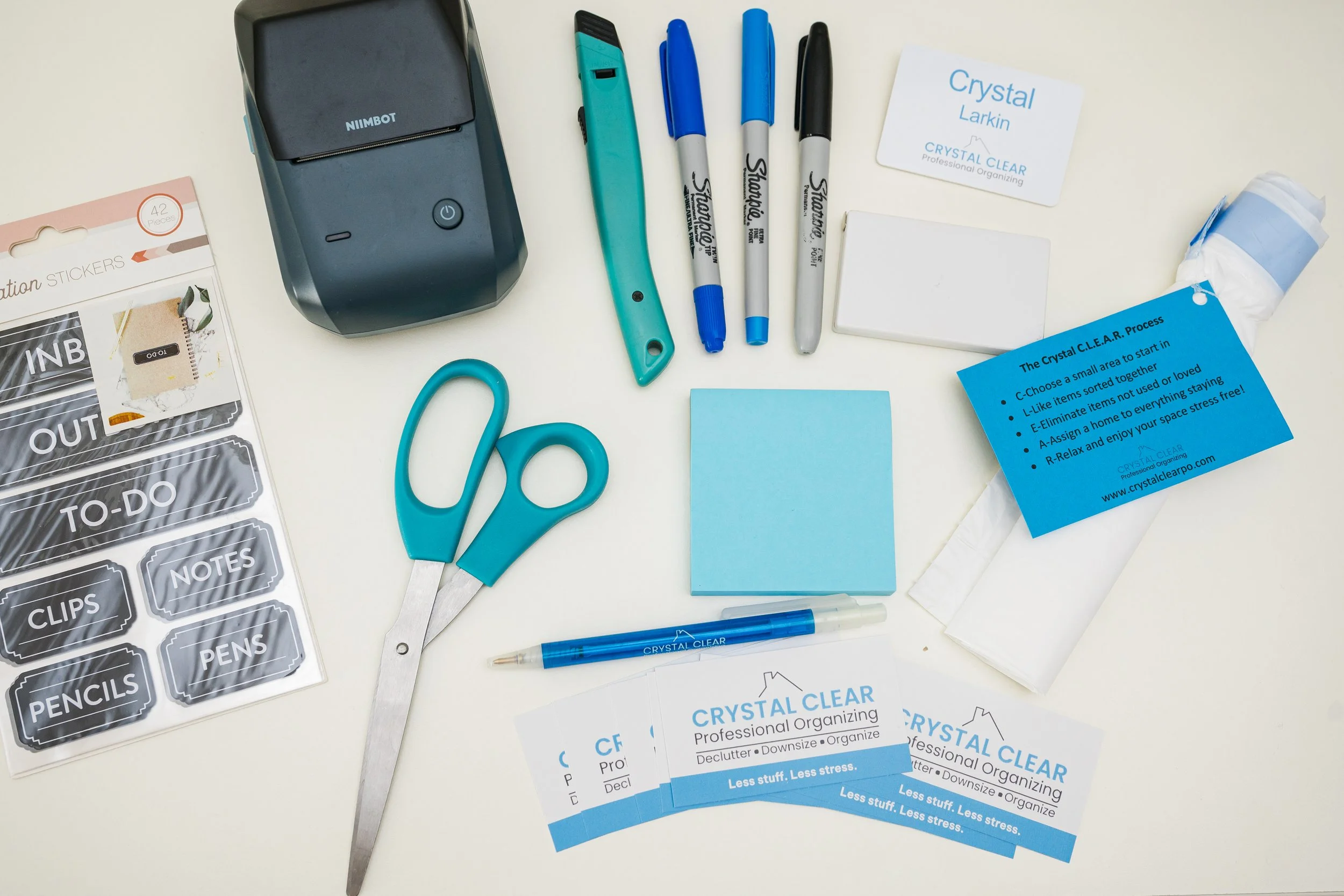 Flat-lay of a planner, phone, and coffee for monthly social media content planning by a business owner.