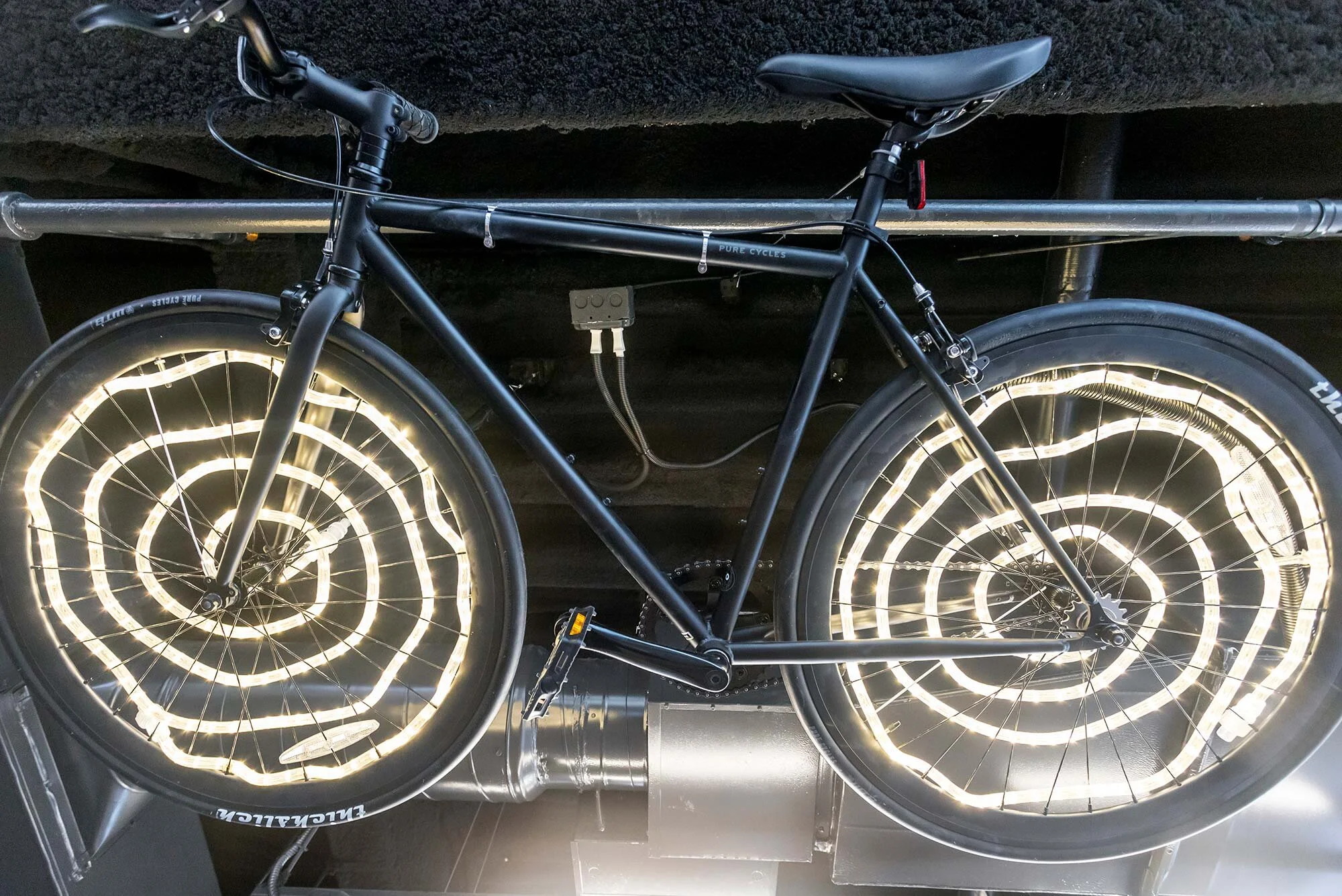 A close up of the sculptural bicycle lighting in the cafe.