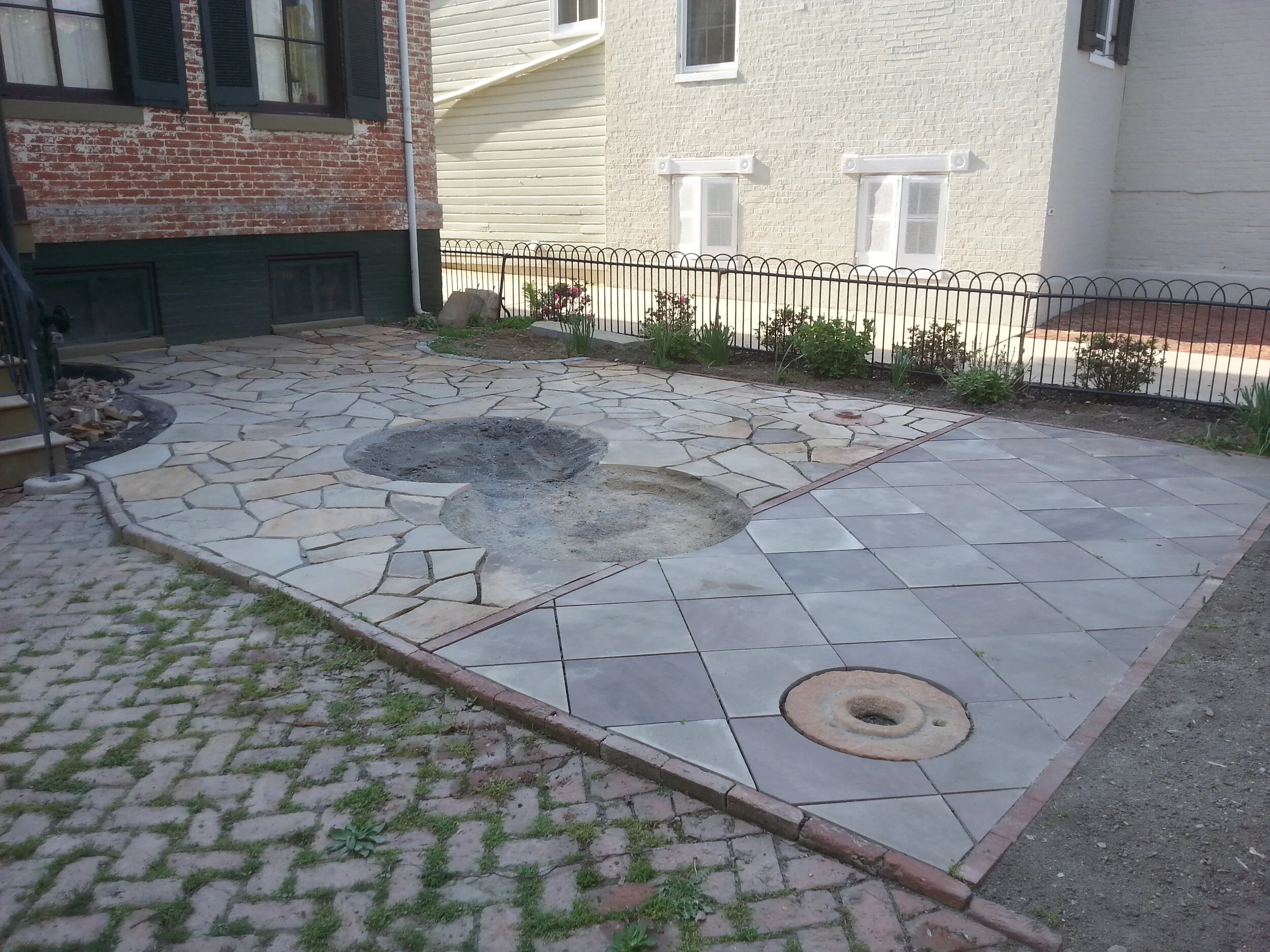 Custom stone patio with areas for plants by Steel and Stone — Designer