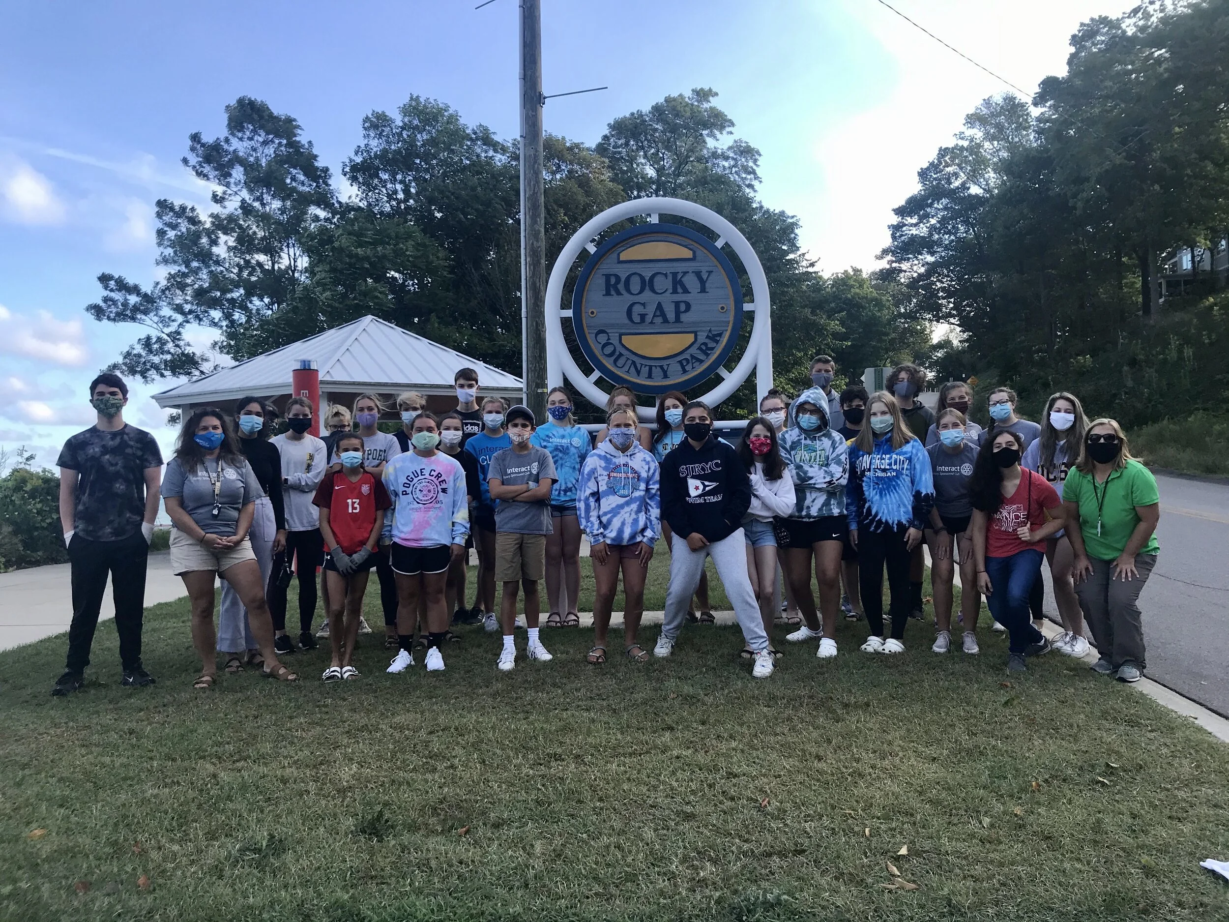 Interactors gather in front of the Rocky Gap sign before the beach clean-up.