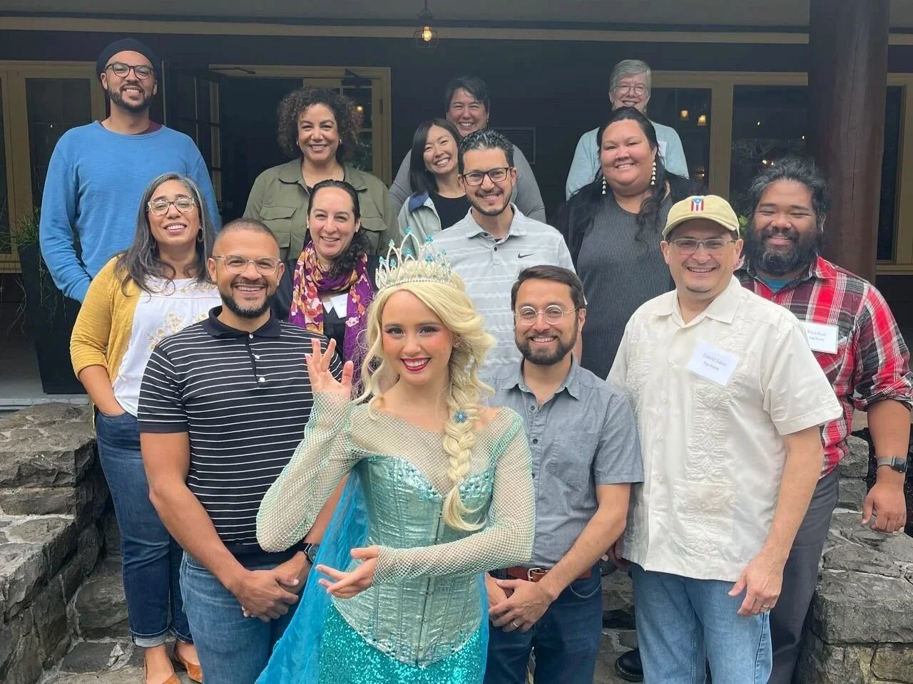 NWHF staff and board members pose on the front steps of a building with someone dressed as Elsa from Frozen.