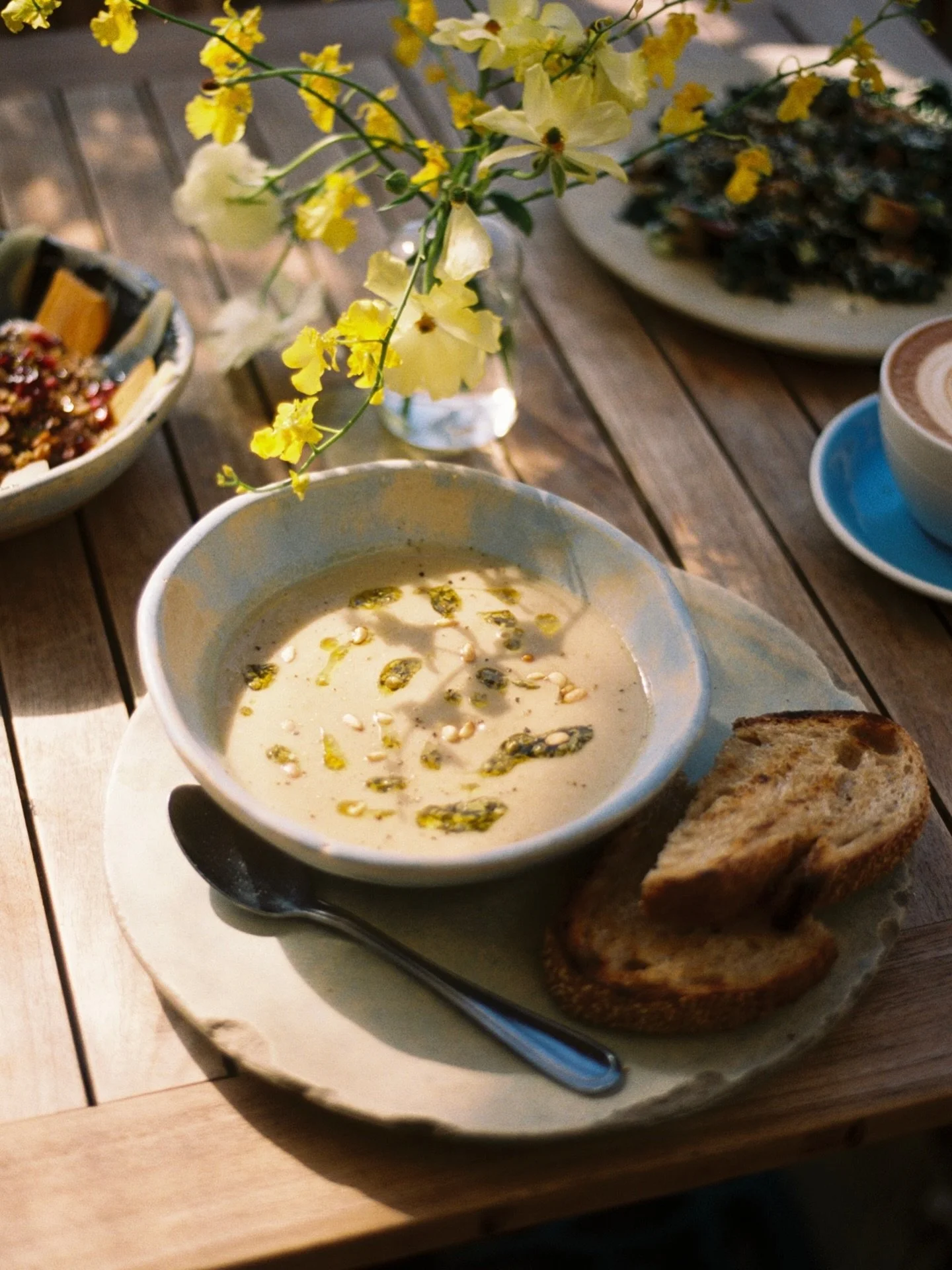 A cold-weather favorite: mushroom + cauliflower soup with pine nuts &amp; herb-caper salsa, served with @gjustabakery sesame sourdough.
