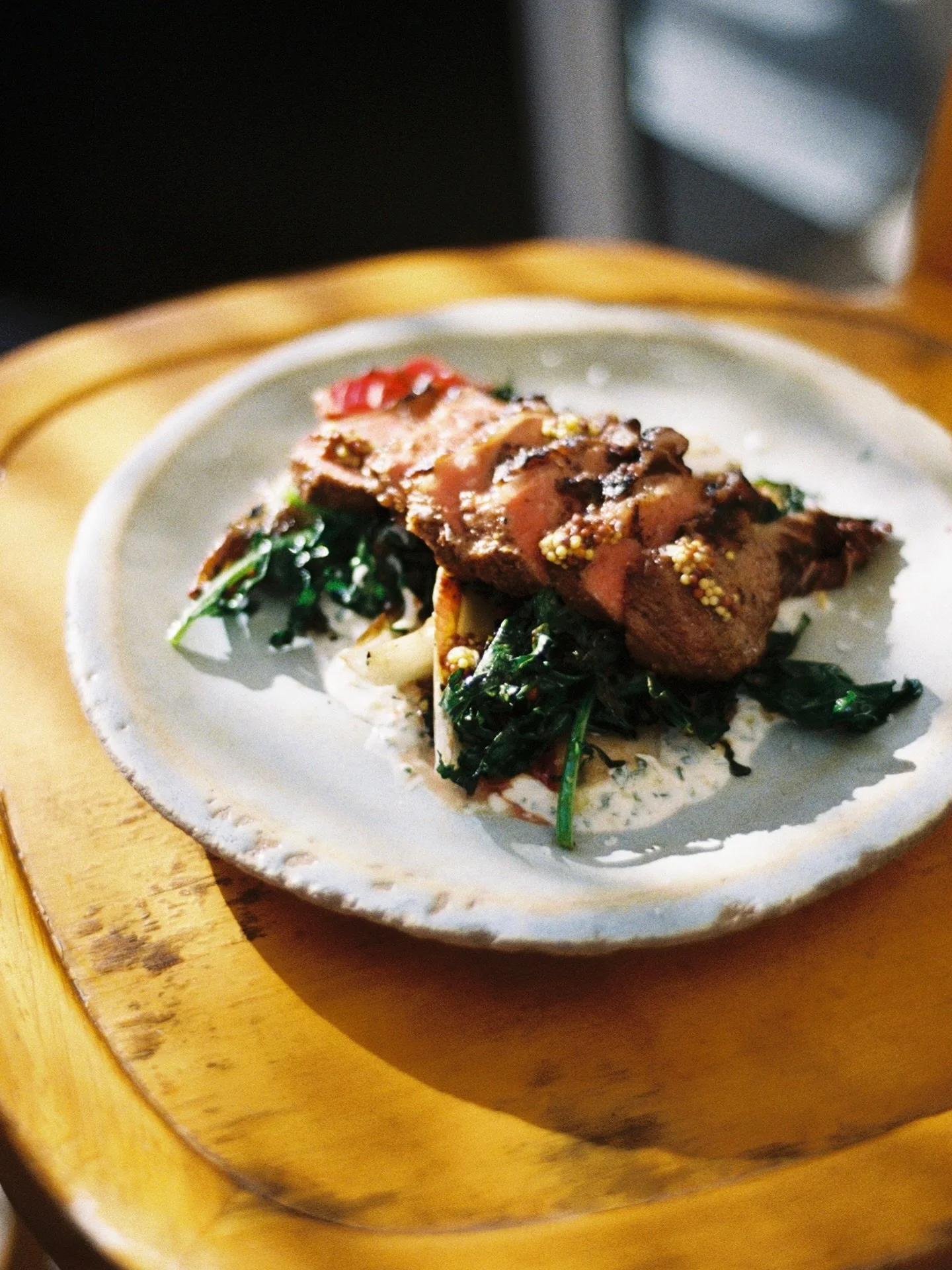 warm off the grill and layered with bright flavor. grilled lamb with meyer lemon herbed yogurt, grilled greens, fresno chili &amp; tarragon. ✨