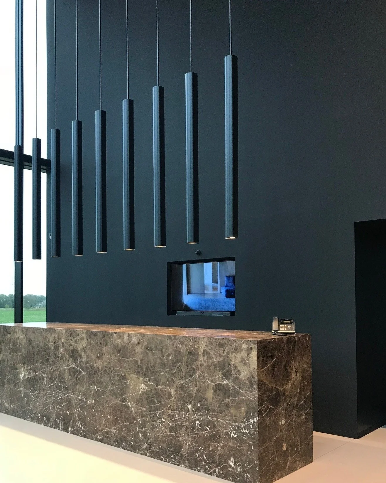 A sculptural reception desk in Emperador Dark leatherlook marble,
paired with custom vertical lighting elements in perfect alignment.

Custom design for OSTA.

Light design: @maghaliedooms
Light production: tailor-made with local craftsmen and @wever
