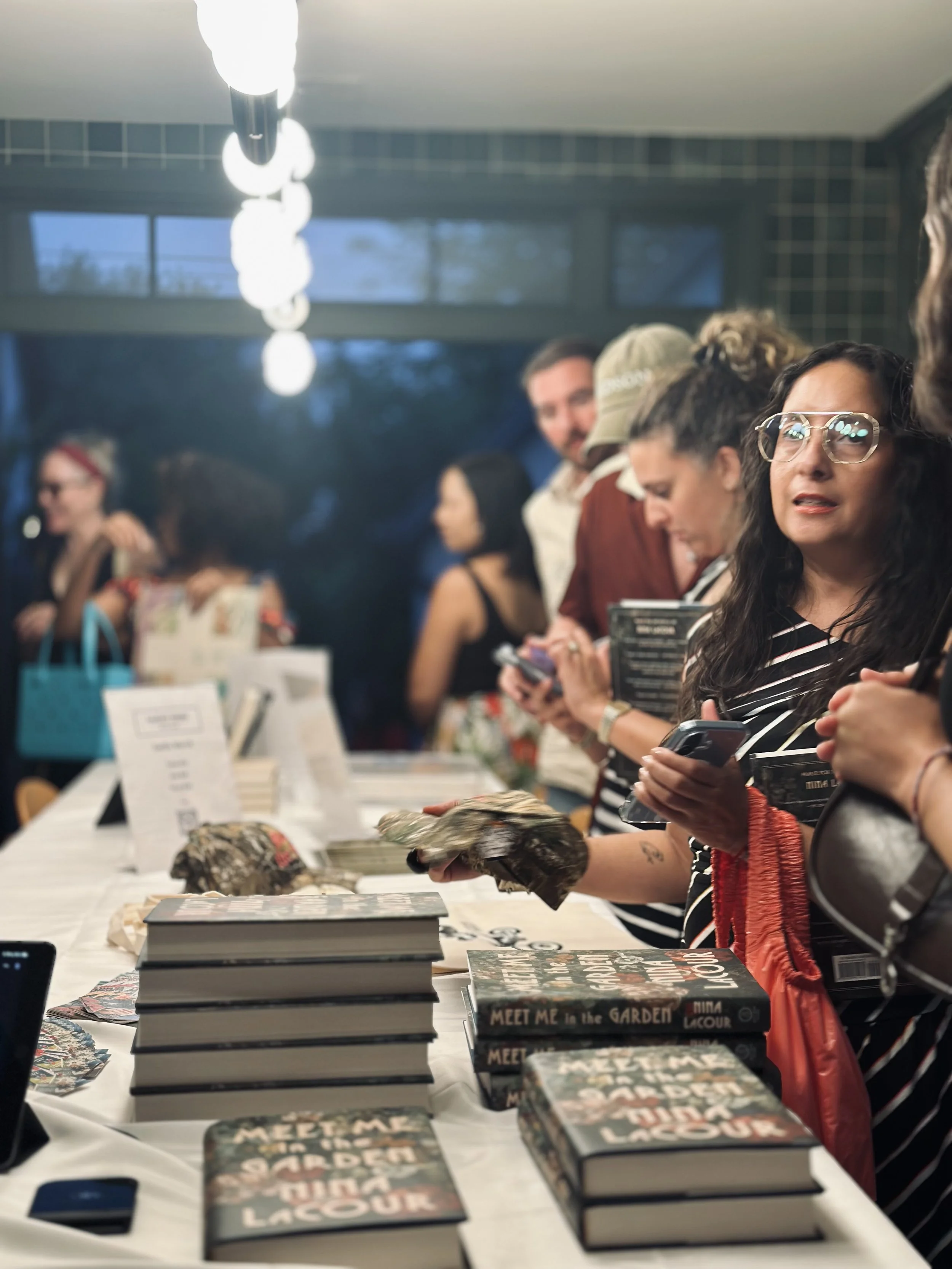 Performers selling books and merch at our inaugural Garden Series event