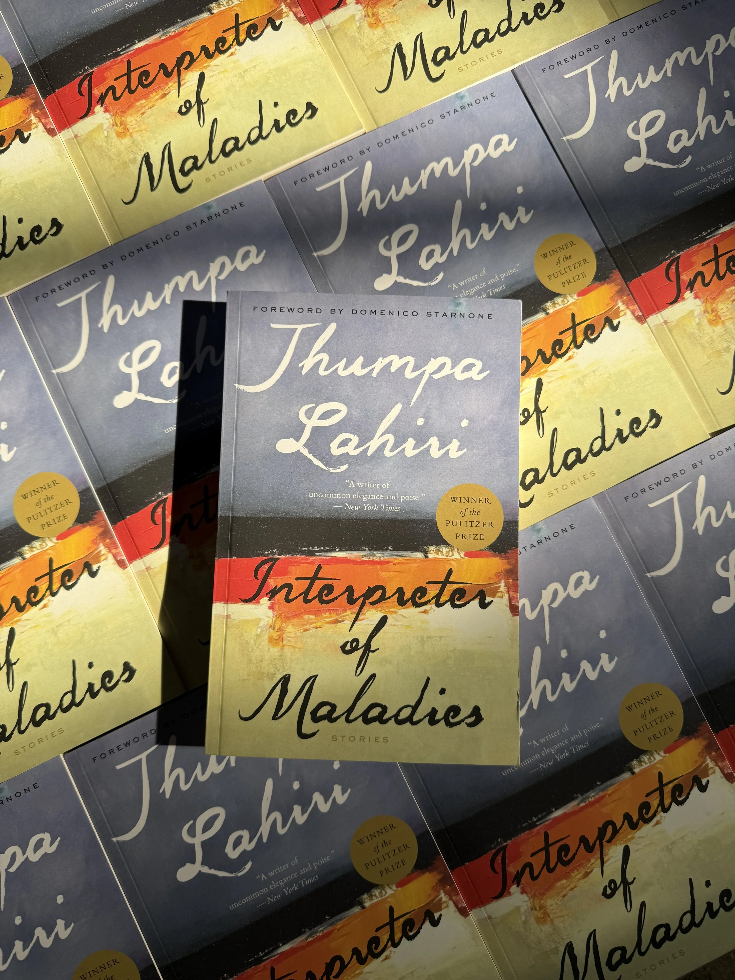 A row of the same paperback book with a blue and yellow cover