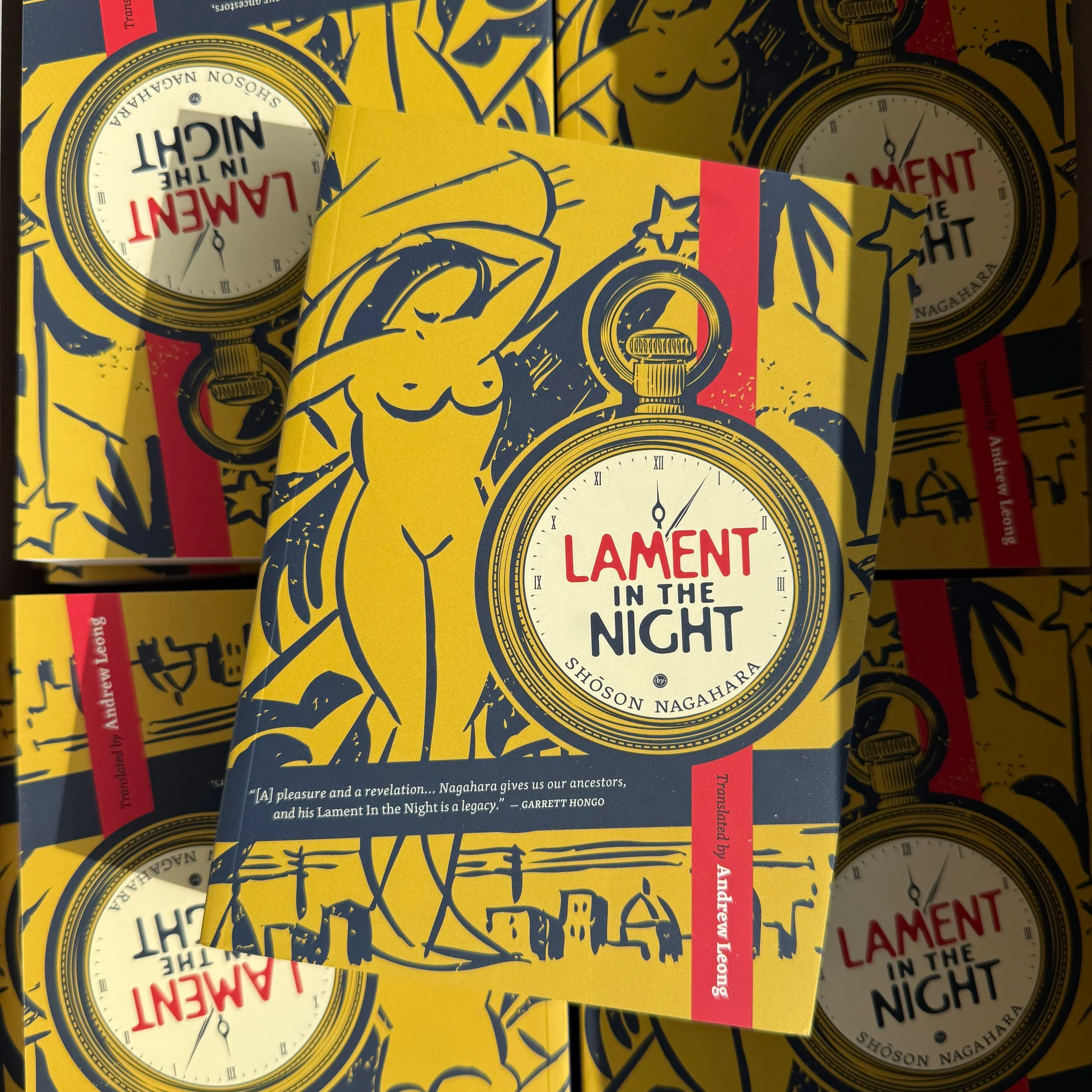 Yellow book cover with pocket watch and female nude imagery