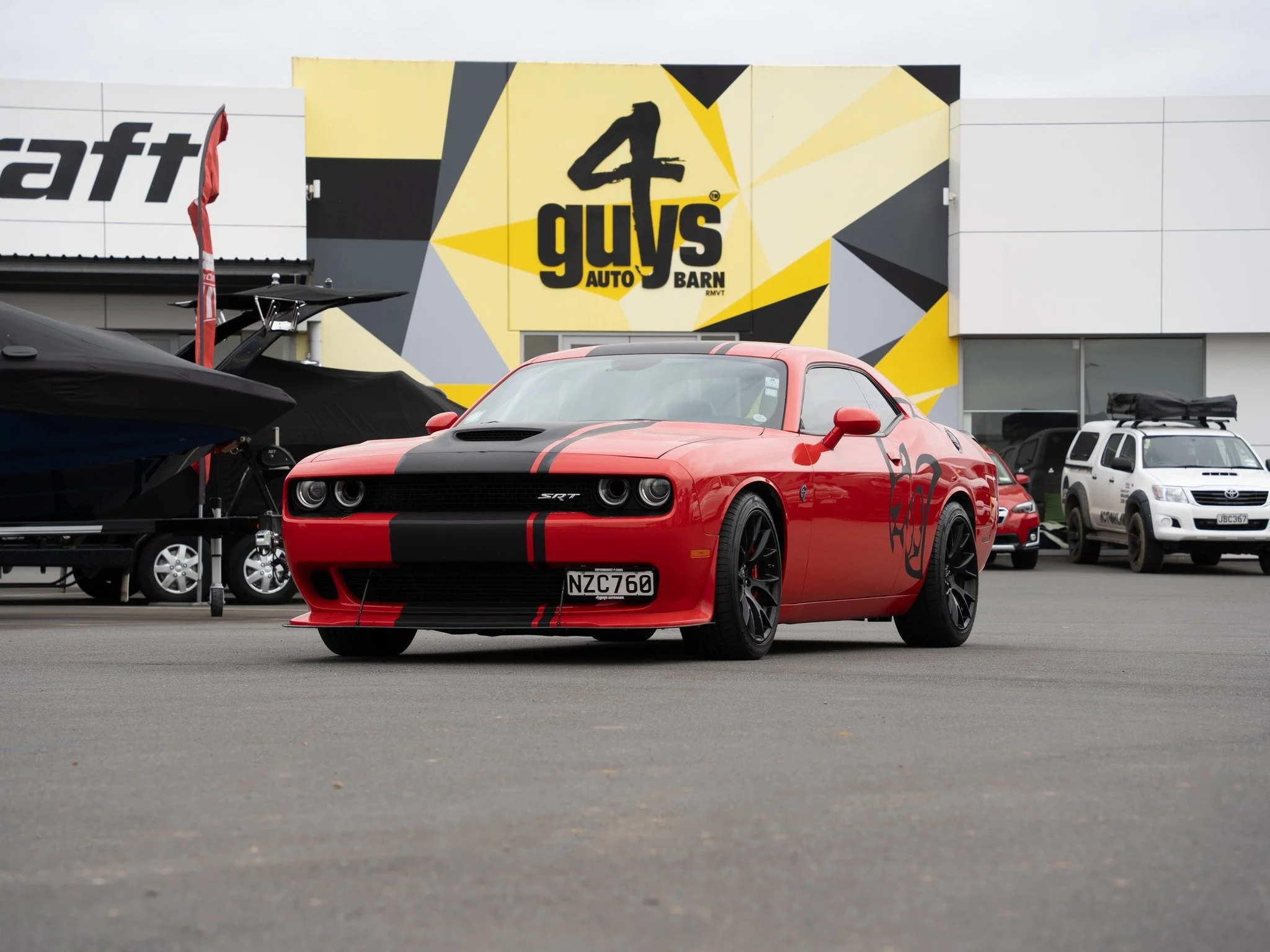 The most powerful muscle car in the world when it launched in 2015.
The 6.2L supercharged HEMI V8 produces 707 horsepower. 

It's supercharger is a 2.4-litre twin-screw unit that can push 11.6 psi of boost, and it consumes 80 horsepower just to spin 