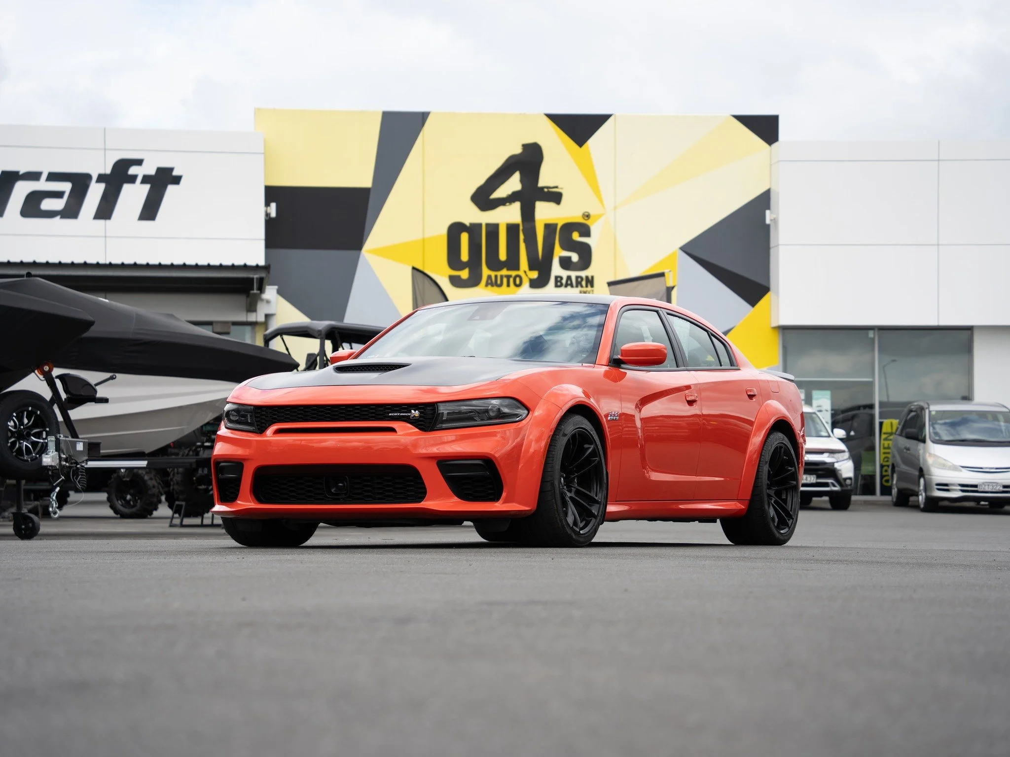 This 2022 Dodge Charger SCAT PACK 392 WIDEBODY has just got off the ship and arrived at the yard! 

Powered by a 6.4L EFI HEMI V8 producing 485hp with MDS (Multi-Displacement System), this sedan offers thrilling acceleration and smooth handling. The 