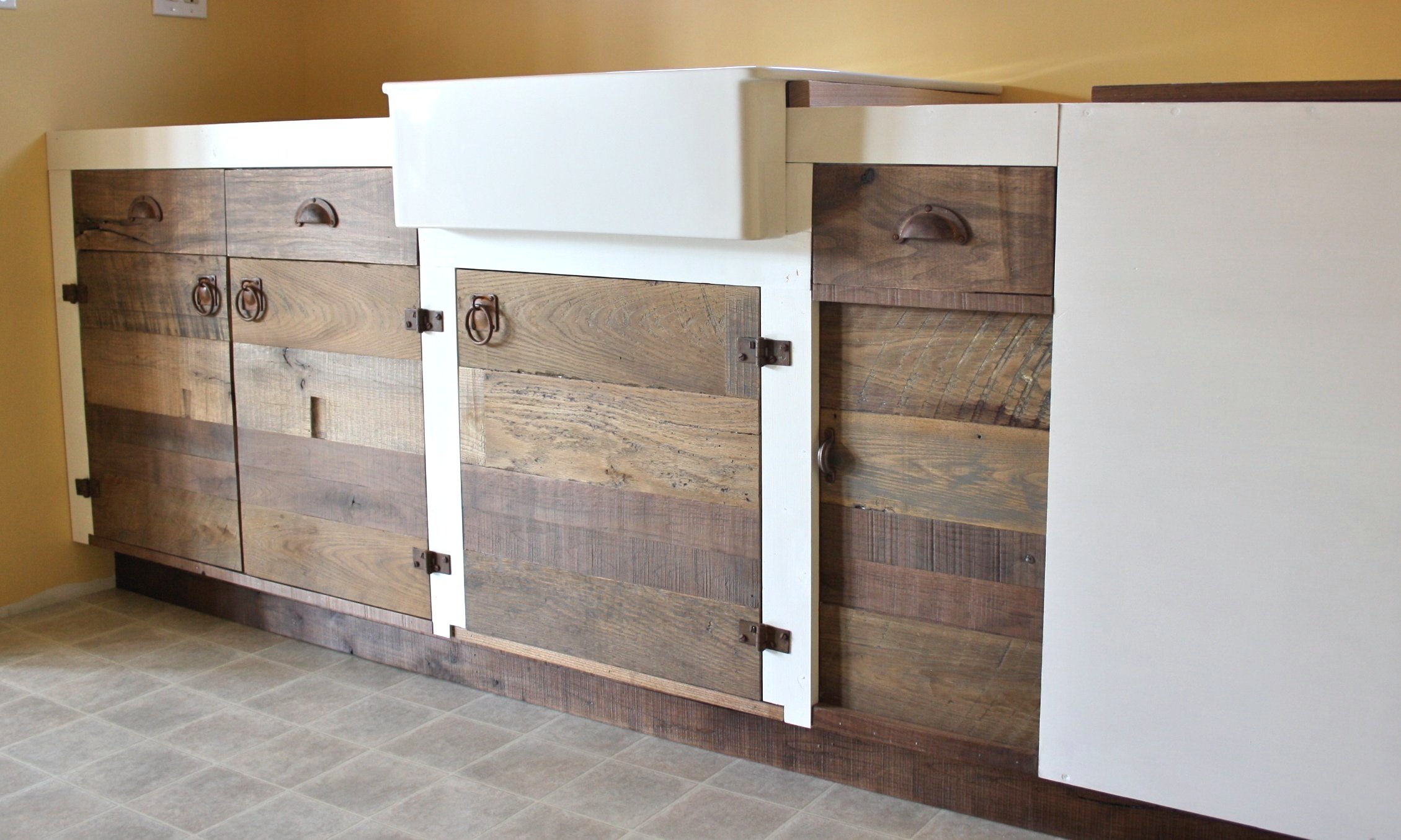 Full Construction and Panel Design: Kitchenette addition with salvaged chestnut fronts, white trim and hideaway slider compartment 2012