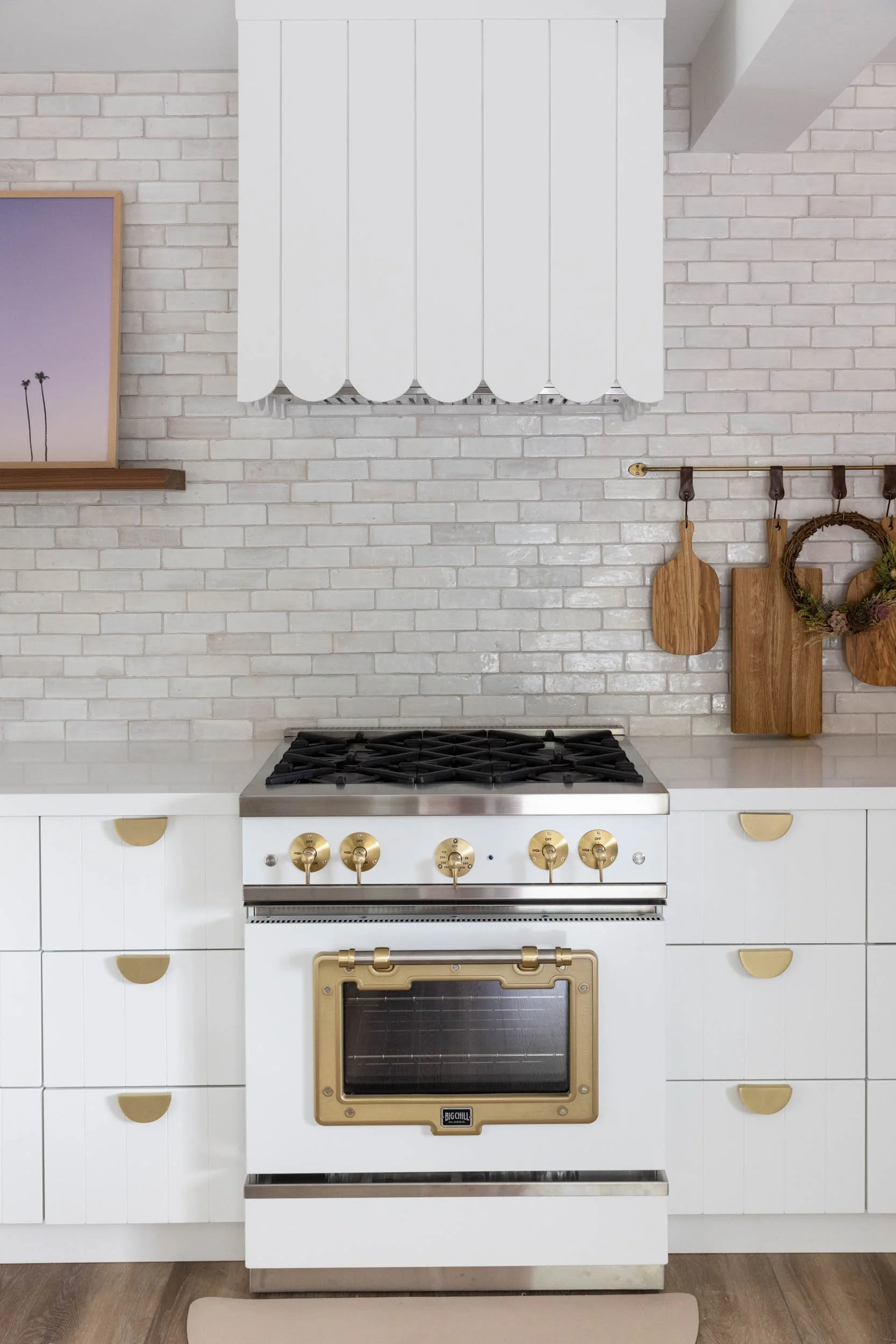 Kitchen range, custom range hood, floating shelf and cutting boards