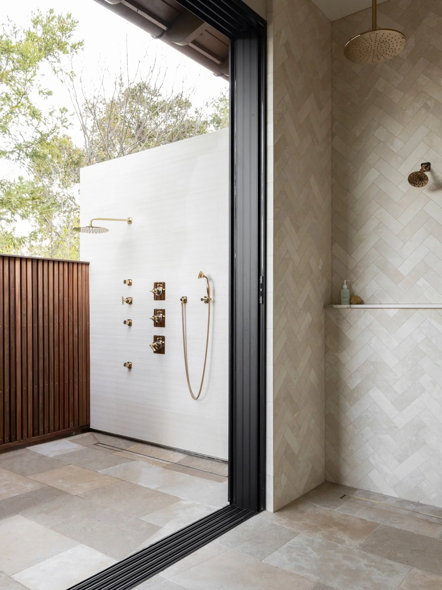Days feel a little more special when your shower opens to the morning sky.
This primary bath leads to a private outdoor shower. We carried the same herringbone tile and brass fixtures throughout so everything feels intentional and connected.
Some day