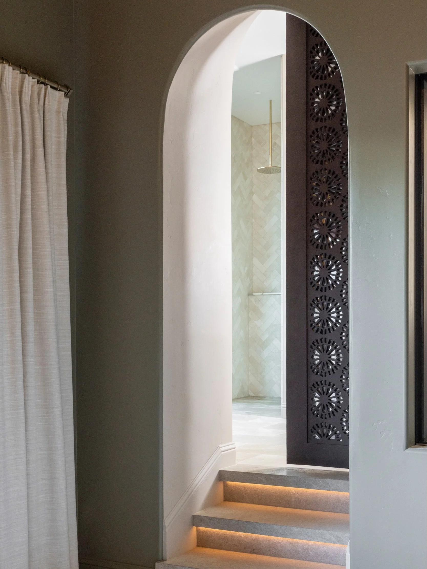 More than meets the eye 🤍 Every design choice has a story. This door was hand-carved in Morocco, shipped across an ocean, then custom stained until the tone was exactly right. Installed alongside stairs lit from beneath, the extra care shows before 