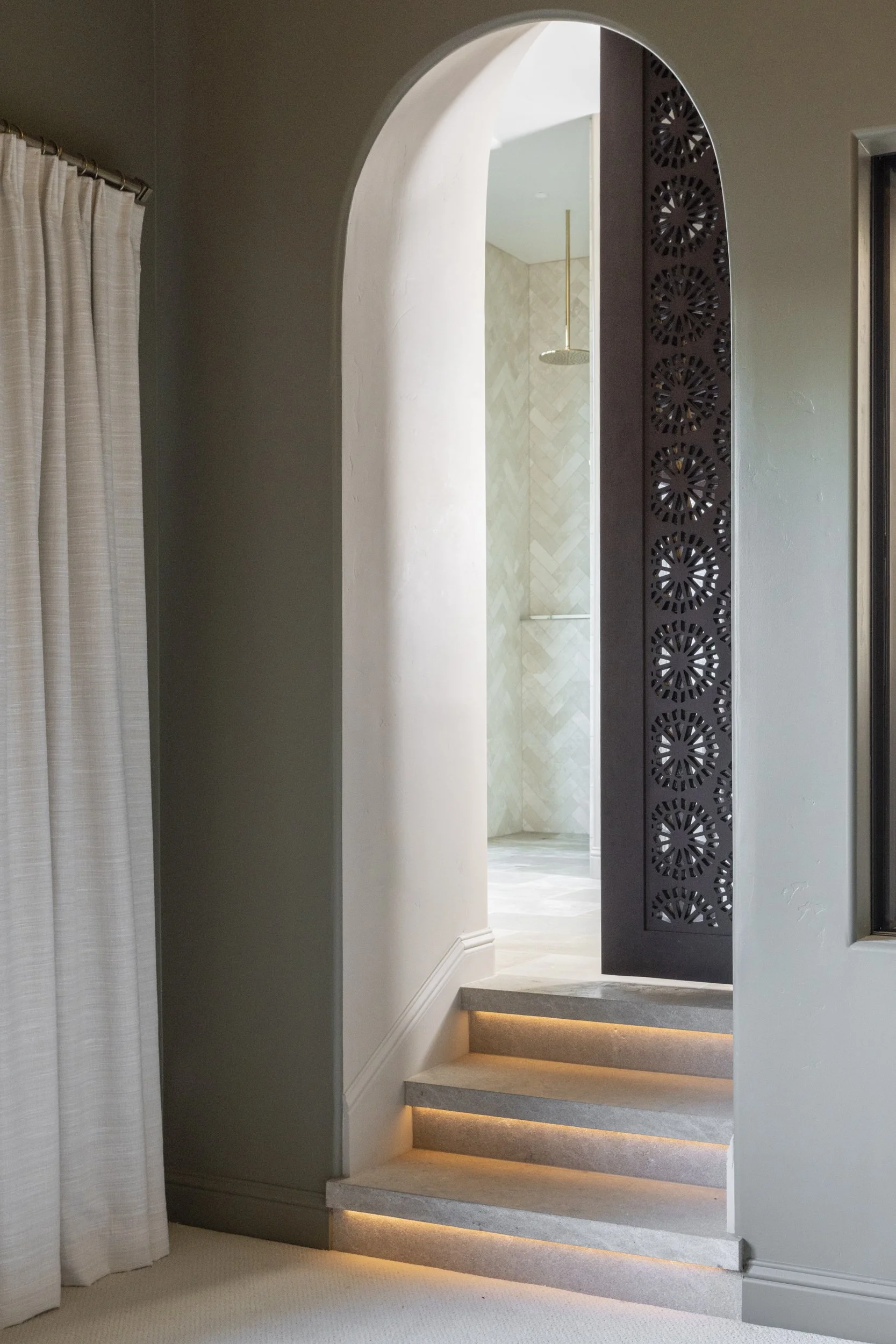 Arch doorway with hand carved wooden door