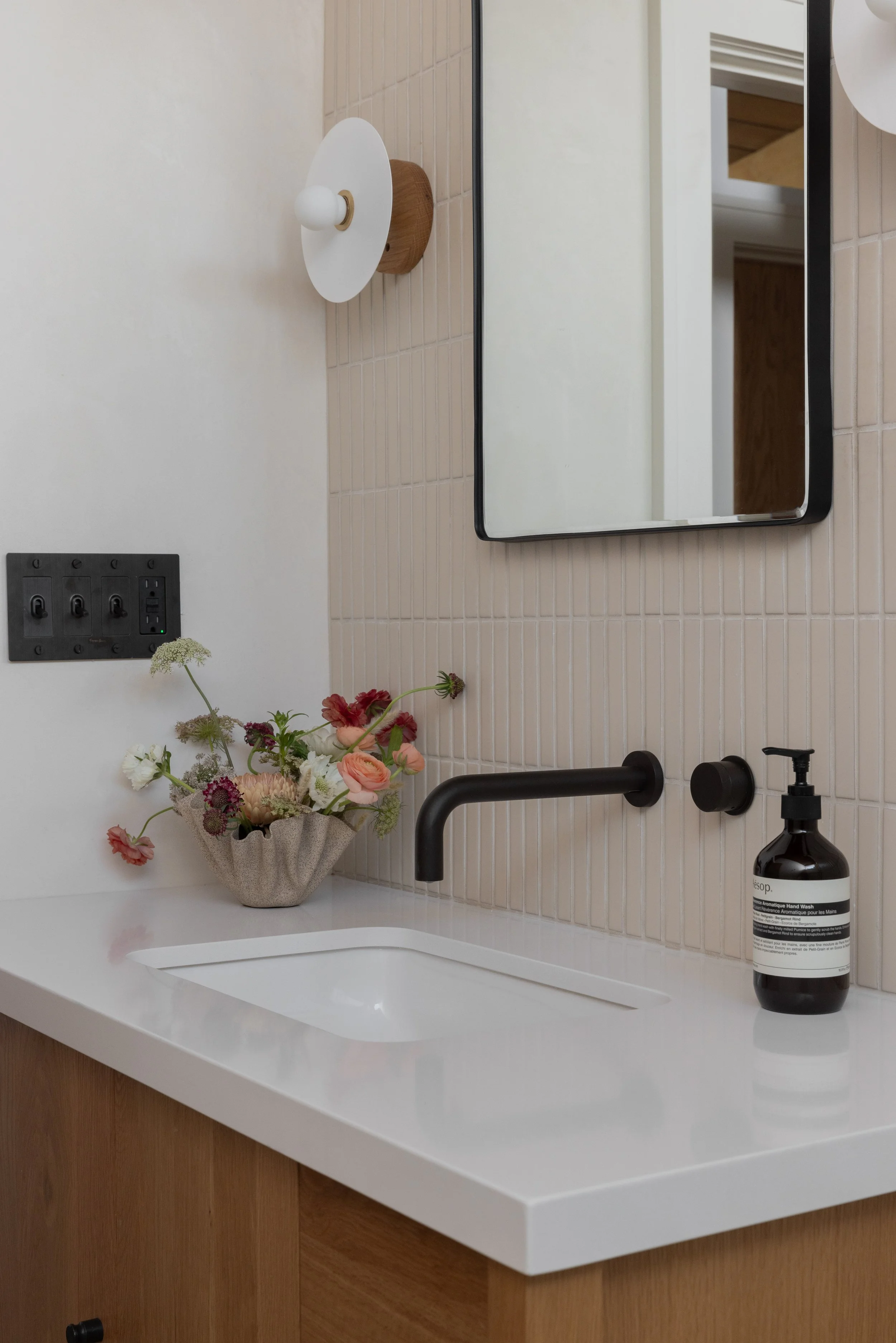 Bathroom vanity, light fixture, sink and light switches