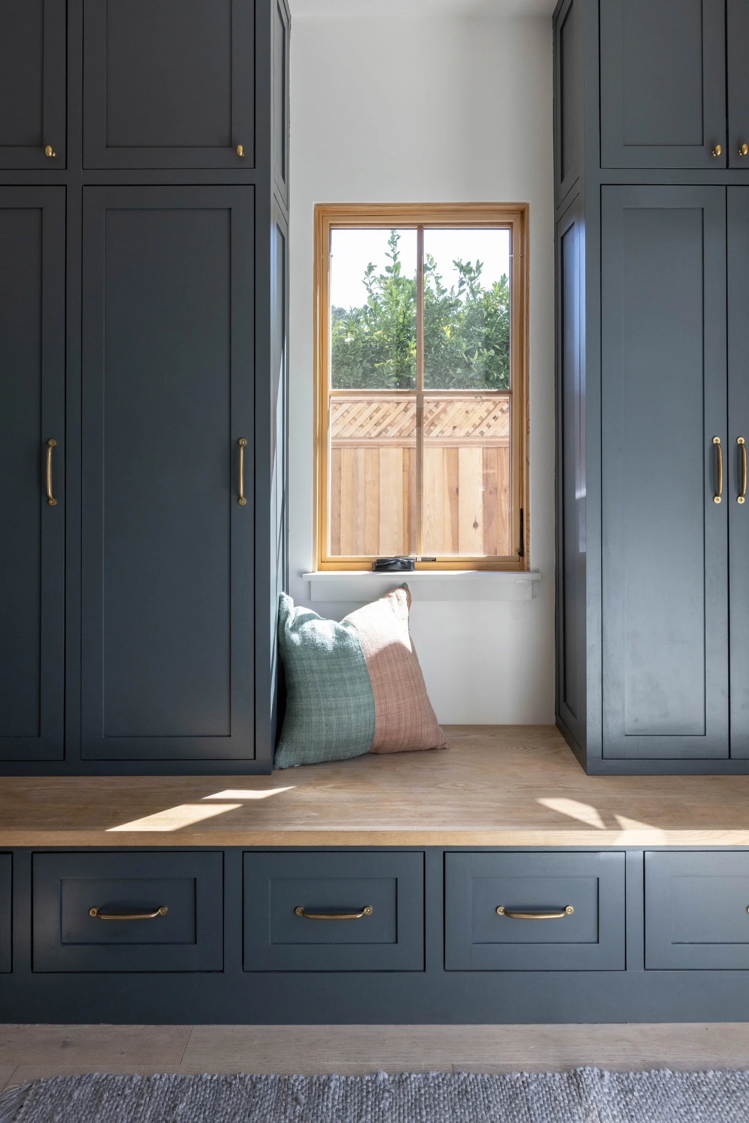Mudroom with storage lockers, bench and reading nook with window