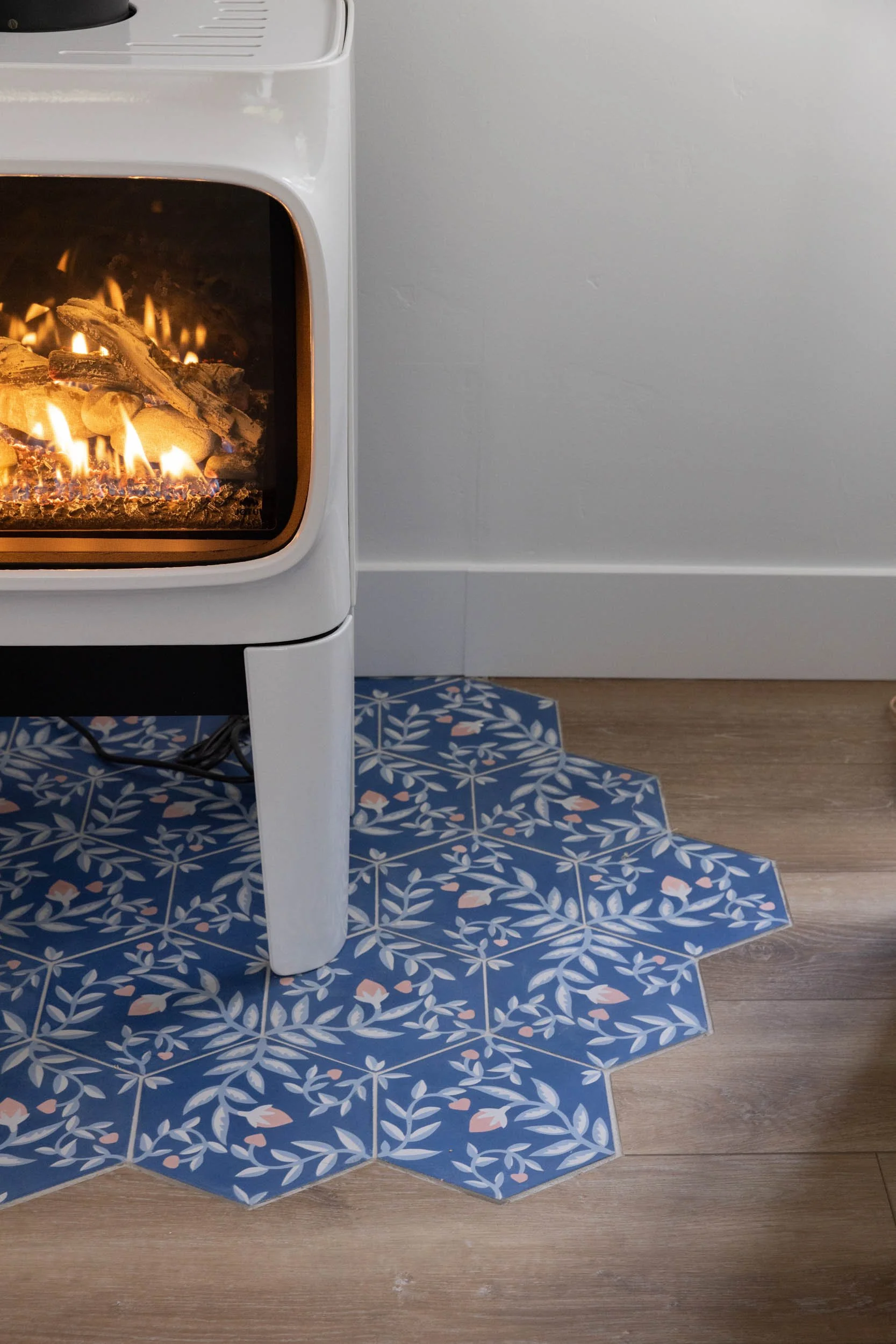 Profile fireplace with tile hearth and wooden floor