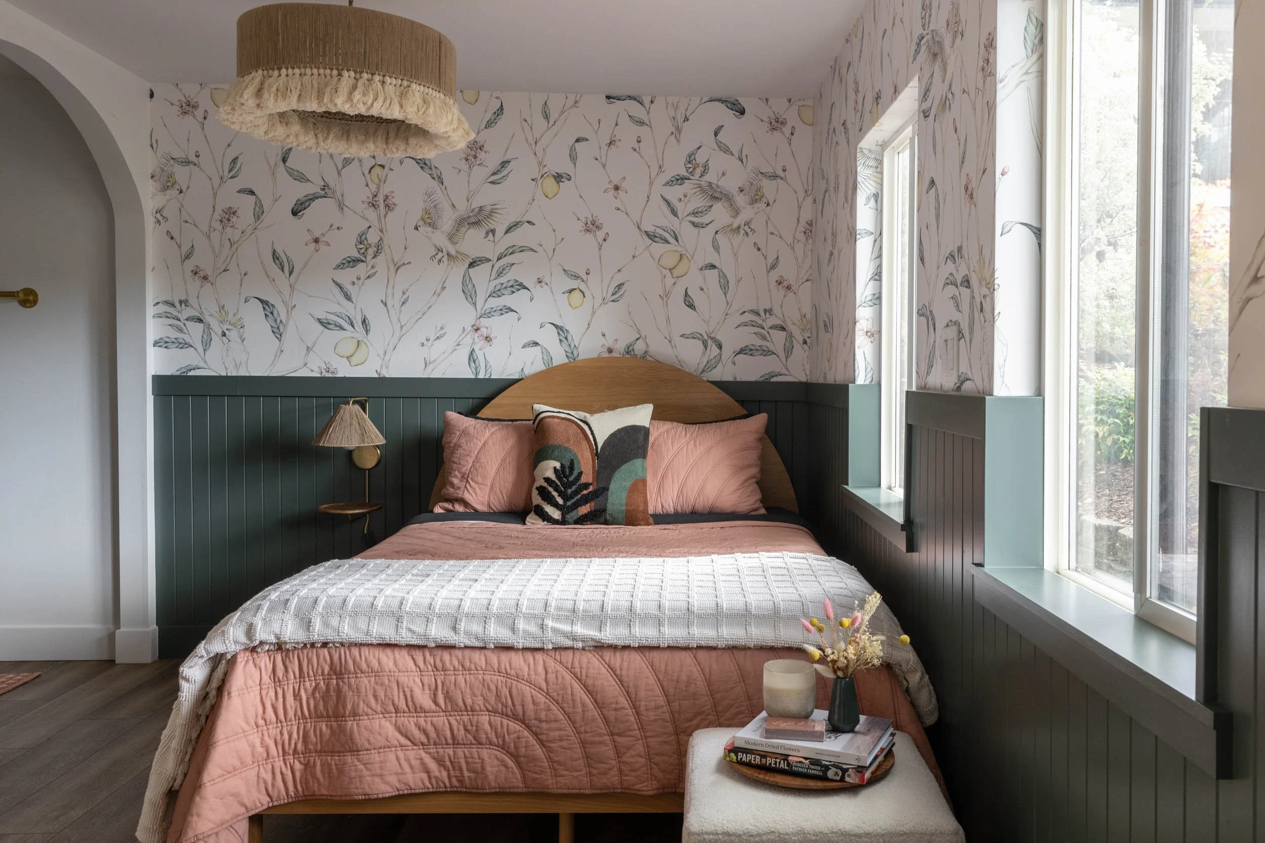 Bedroom with wallpaper, light fixture and custom headboard