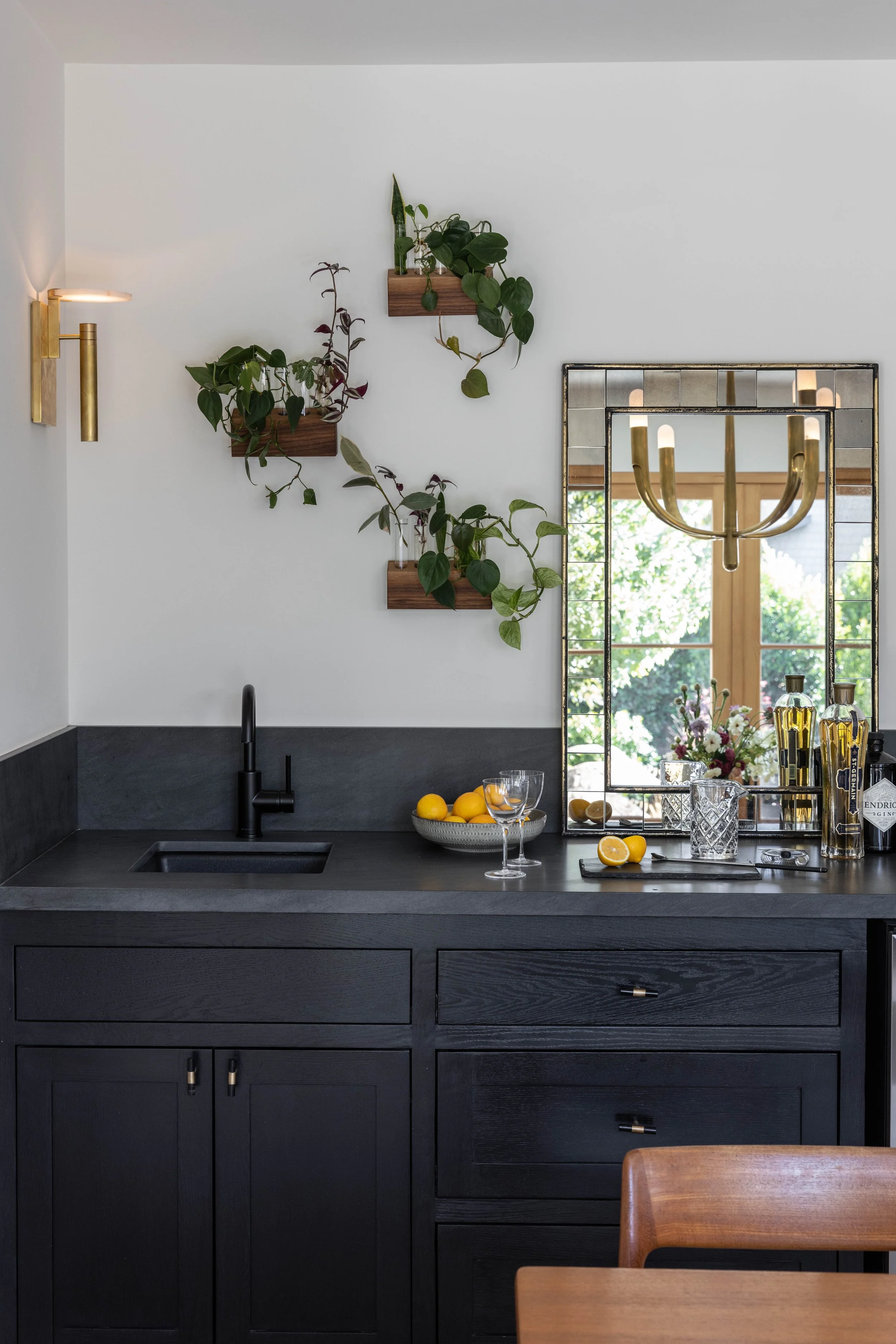Custom lacquered wet bar with wet bar sink and sconce