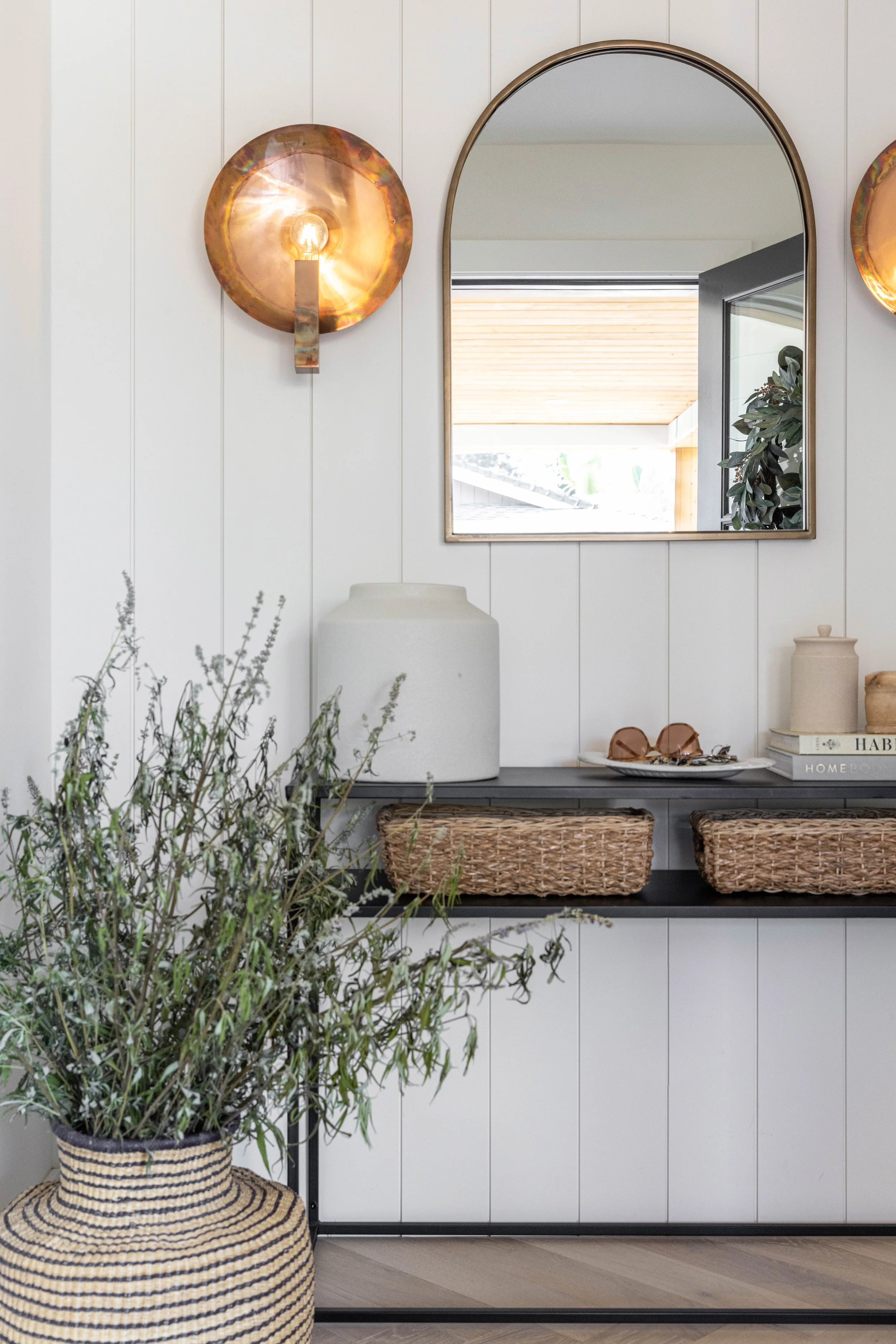 Entry way with mirror and sconces