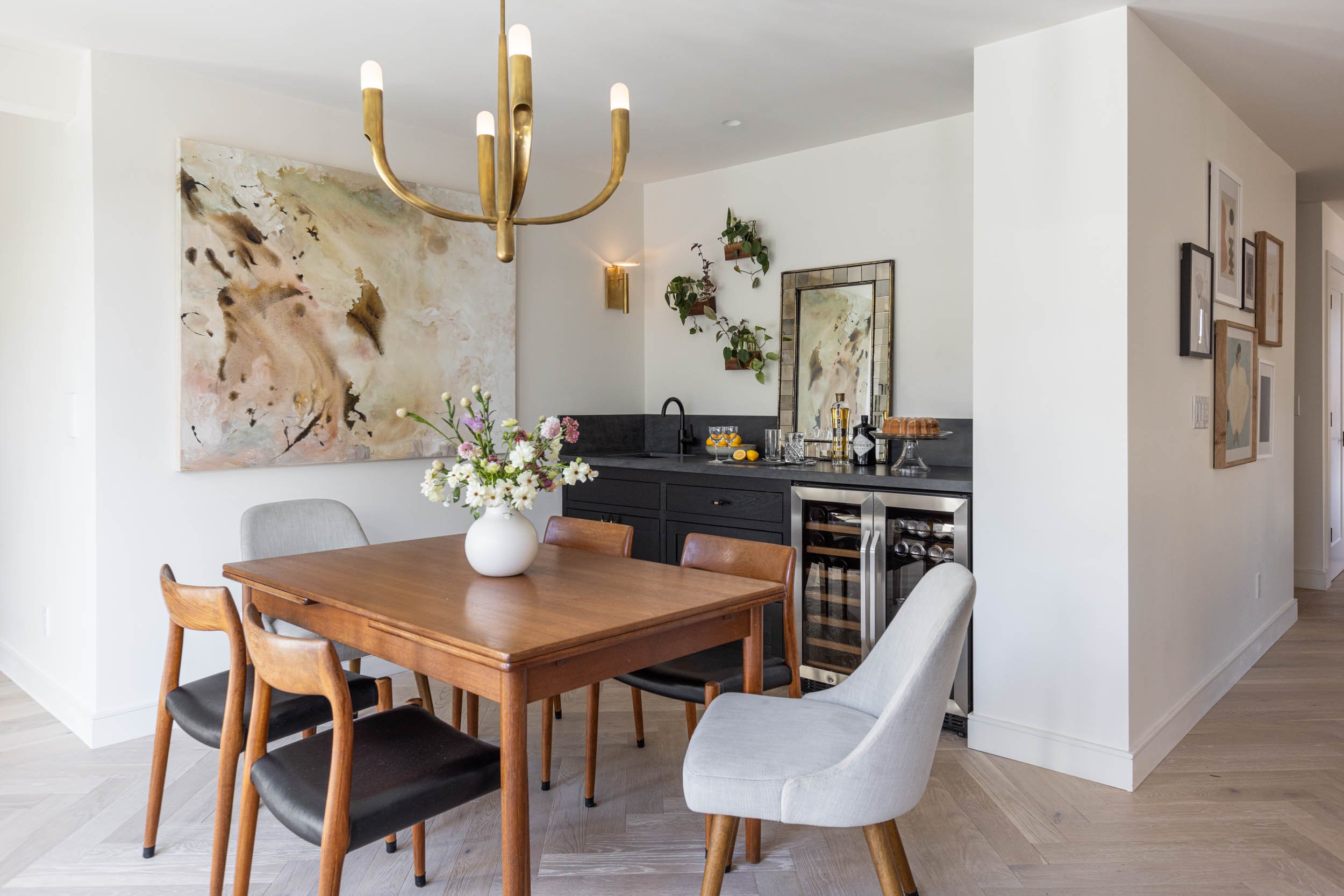 dining room with chandelier and artwork, wet bar with beverage and wine fridge