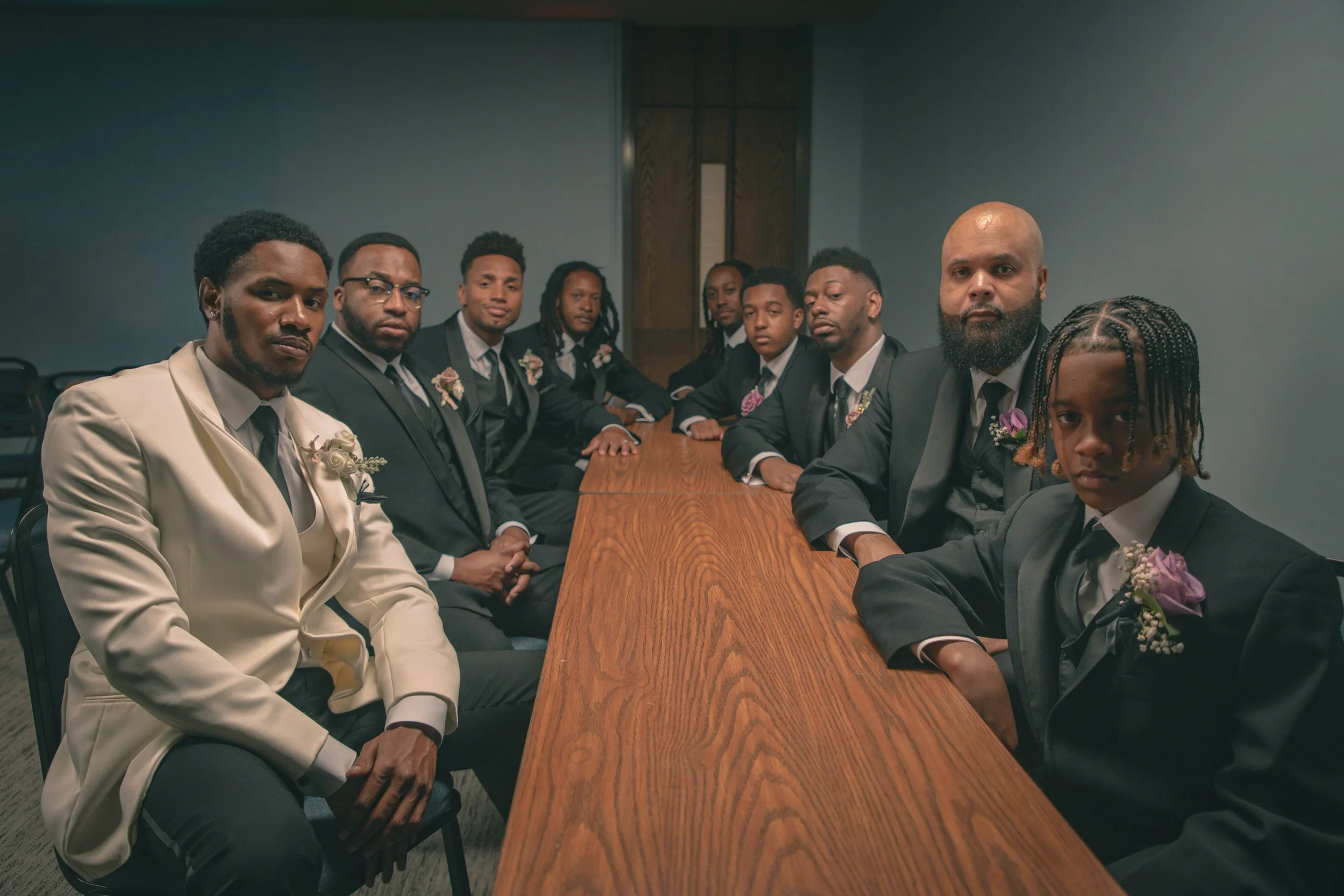 Groomsmen gathered at reception table during Greenville NC wedding celebration.