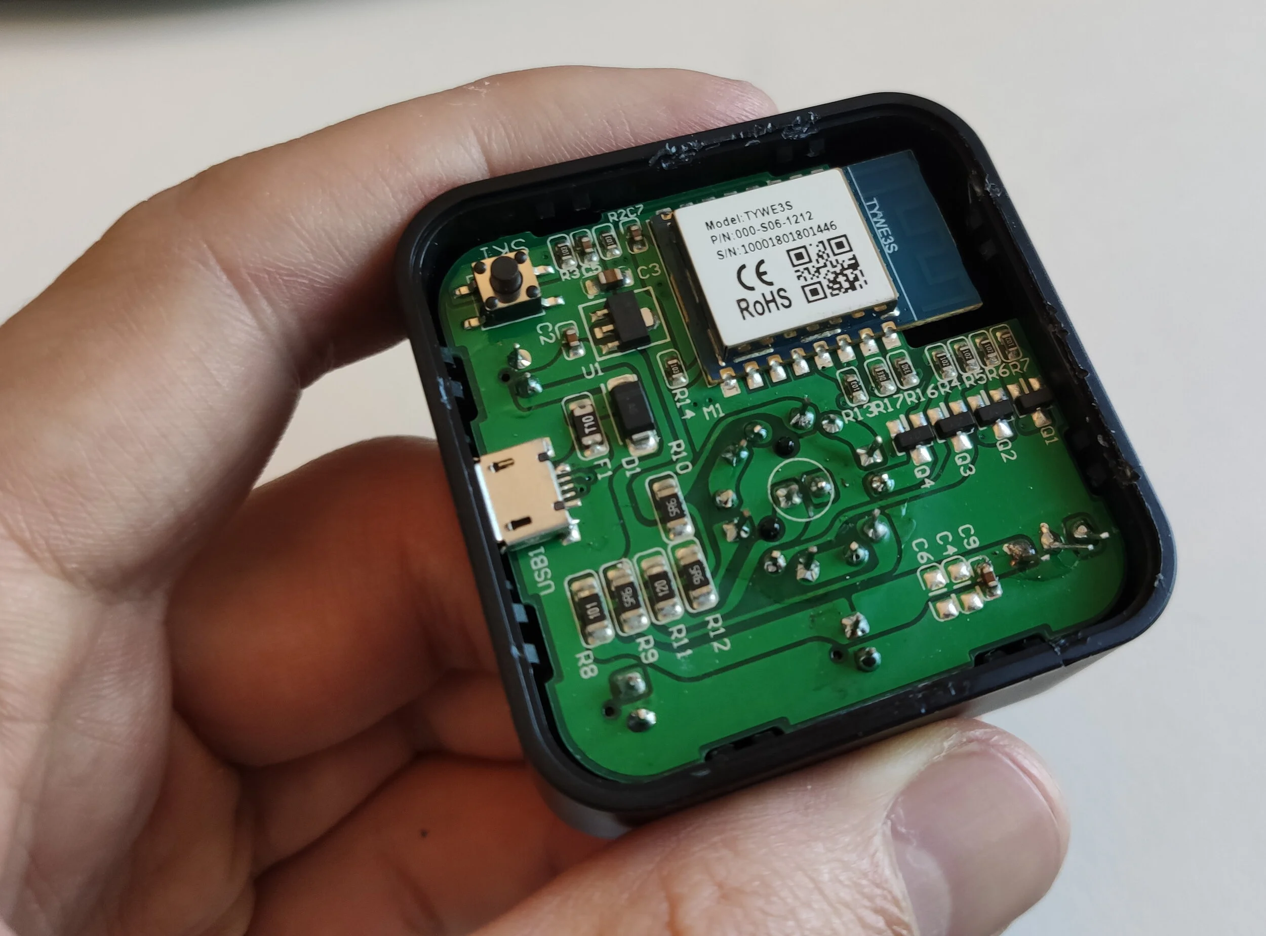 Putting the board back in it's case after soldering leads are removed