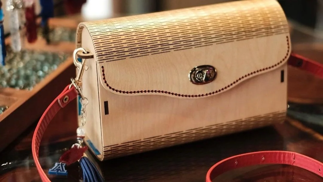 The TimberTote, a handcrafted wooden purse by two Tucson creatives, is building a fashion following. Pictured is the popular University of Arizona Wildcats style with etched lines in the wood and a keychain with a big A on it