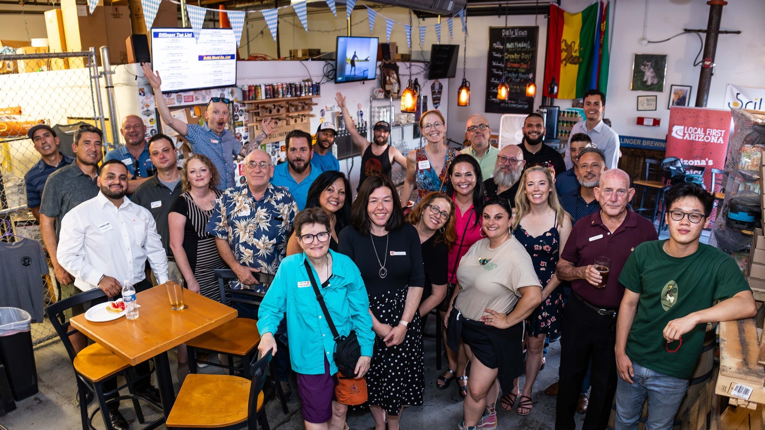 Photo of attendees smiling at Local First Arizona mixer held at Dillinger Brewing Co.