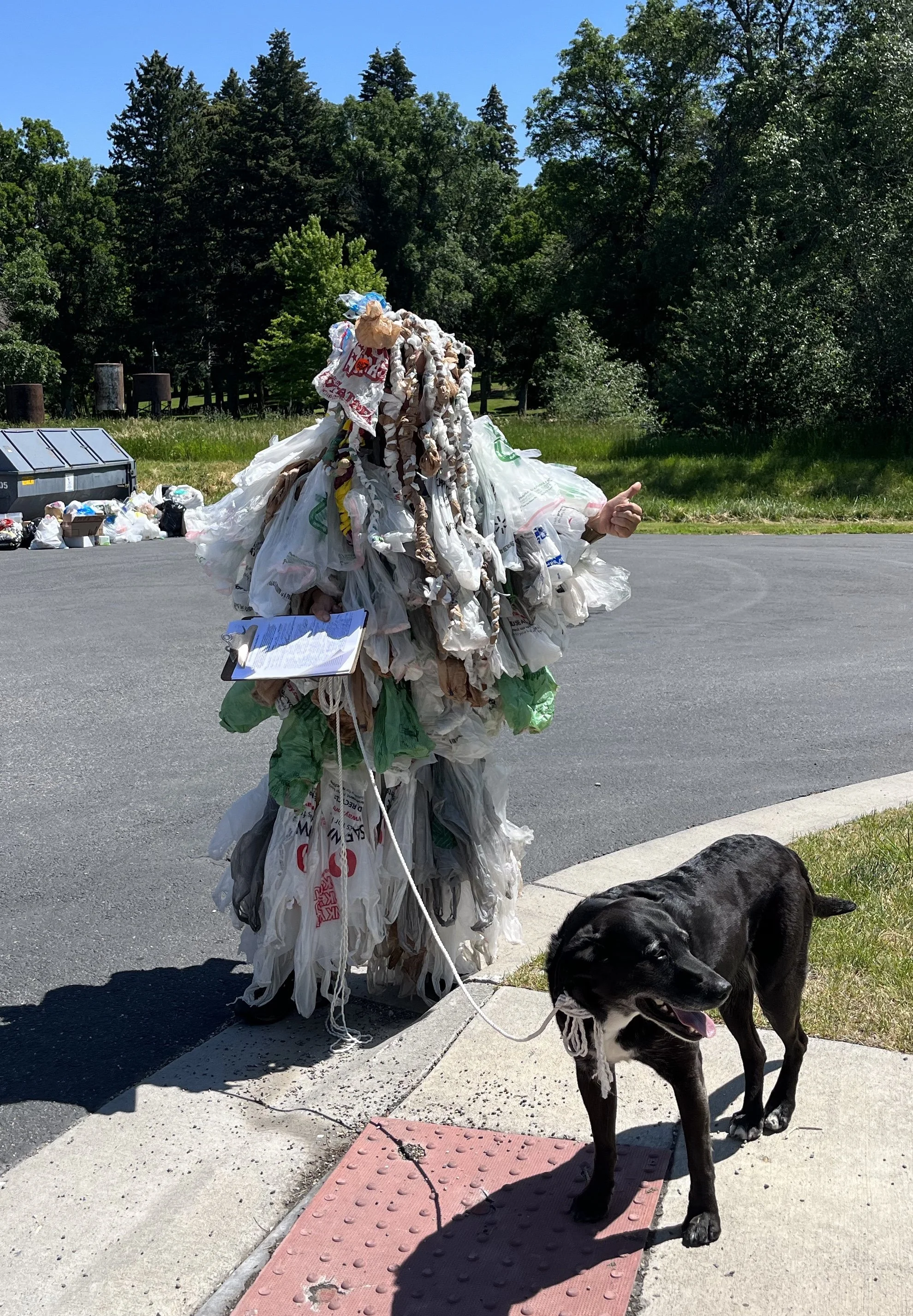 Protesting the passing out of free plastic bags outside the library