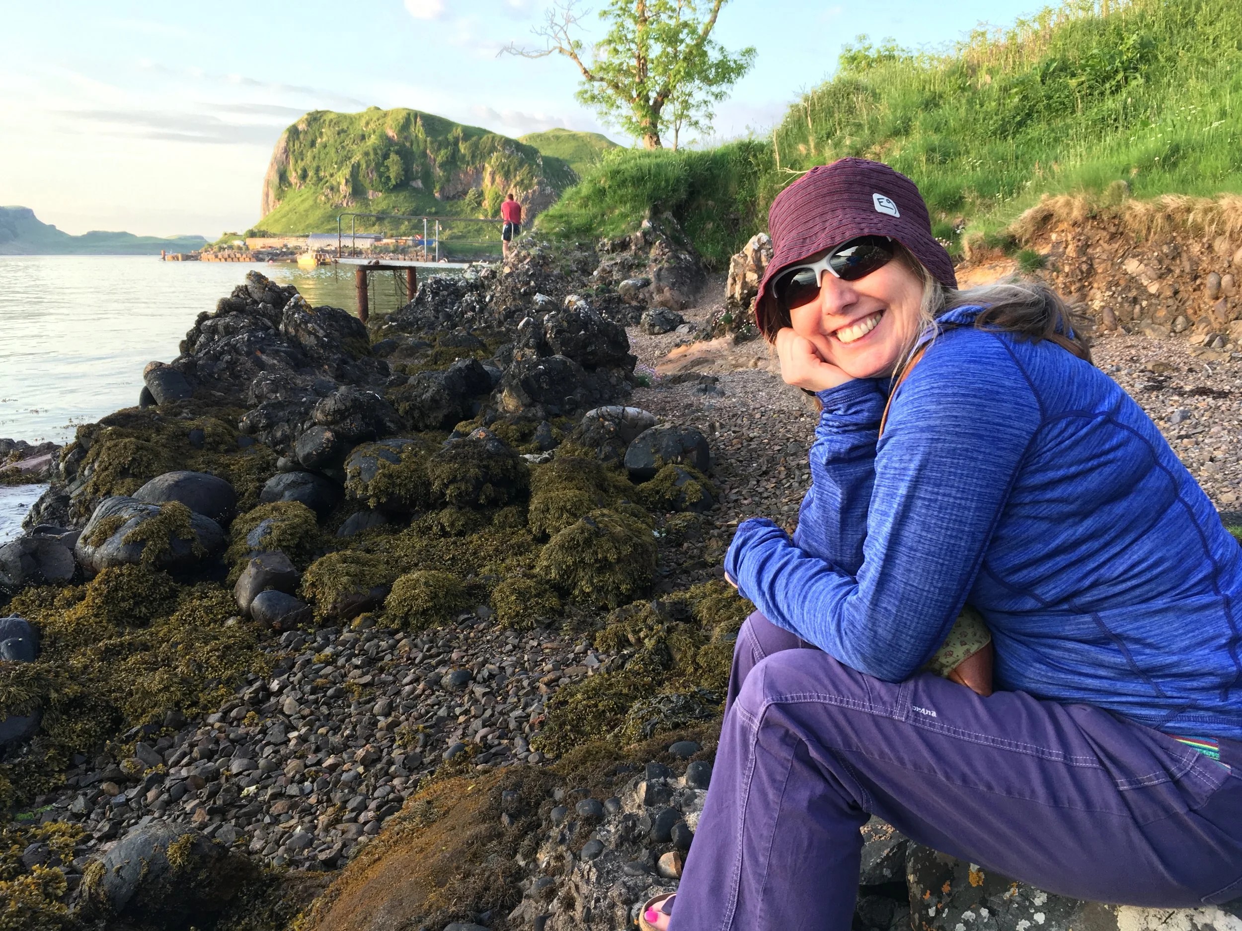 The author sitting by the shore wearing sunglasses, enjoying the evening sun