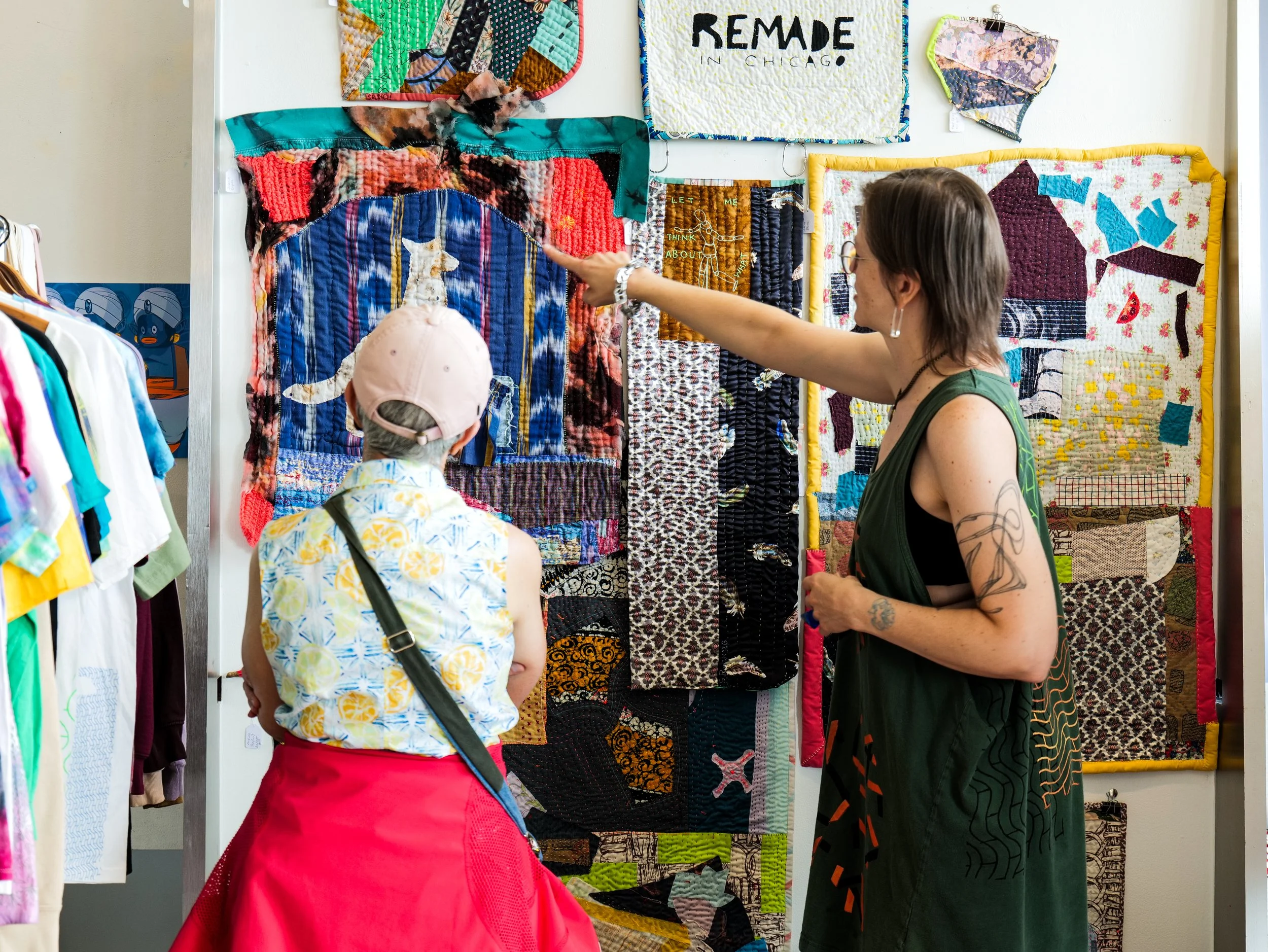Sheri with Remade in Chicago describing quilts to shopper at Trashy Market