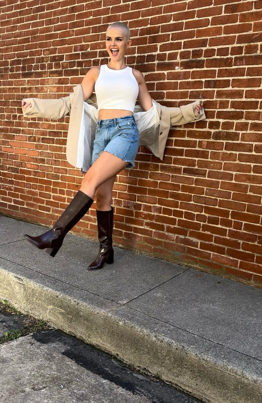 Image of Seana Isaac kicking her leg up and flashing a big smile