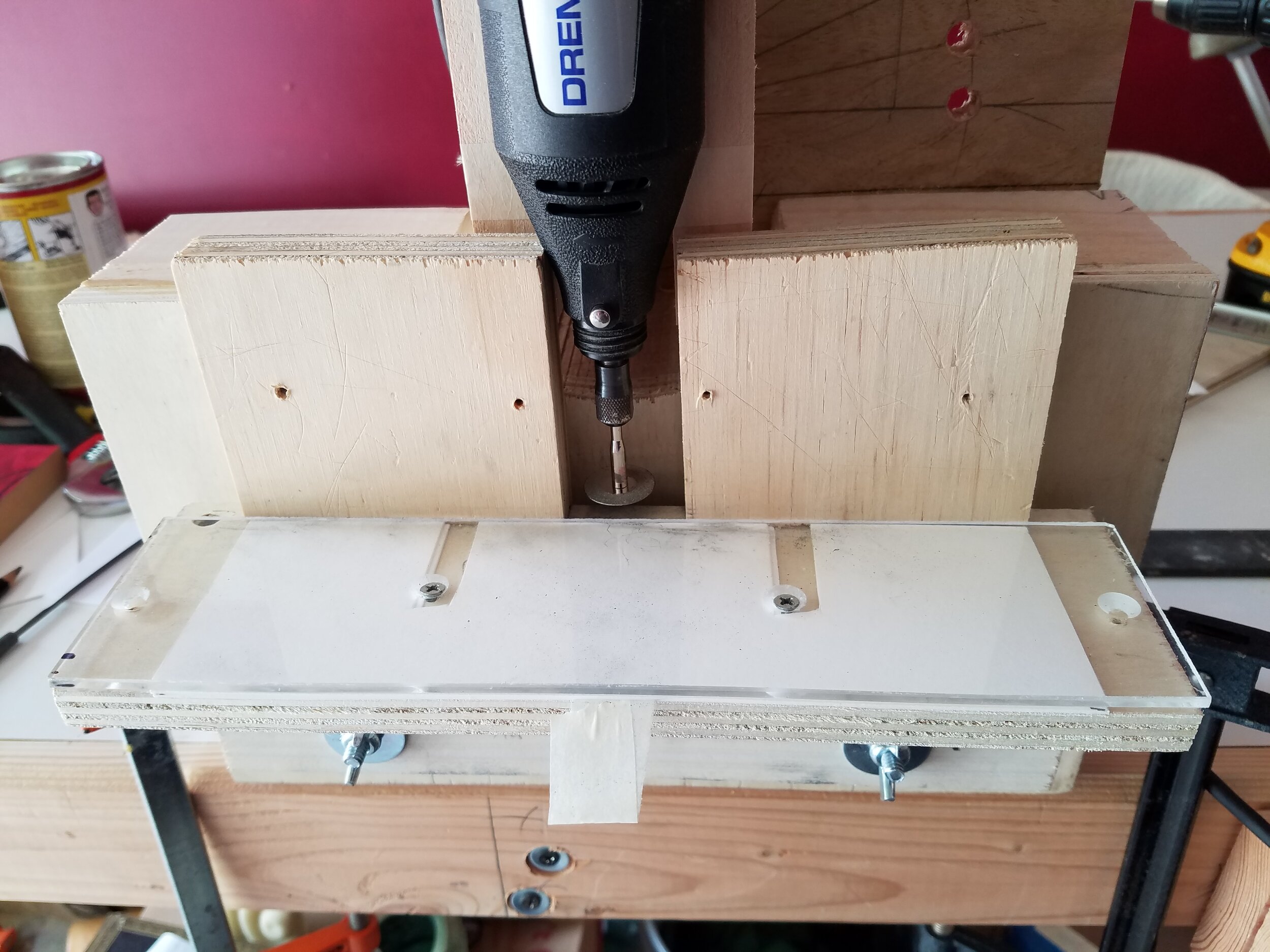  This rotary tool jig allowed me to present the metal graver to a diamond cutting wheel at a consistent angle. The base could be adjusted to allow consistent spacing between cuts. I built in an option to rotate the dremel in case I needed that in the