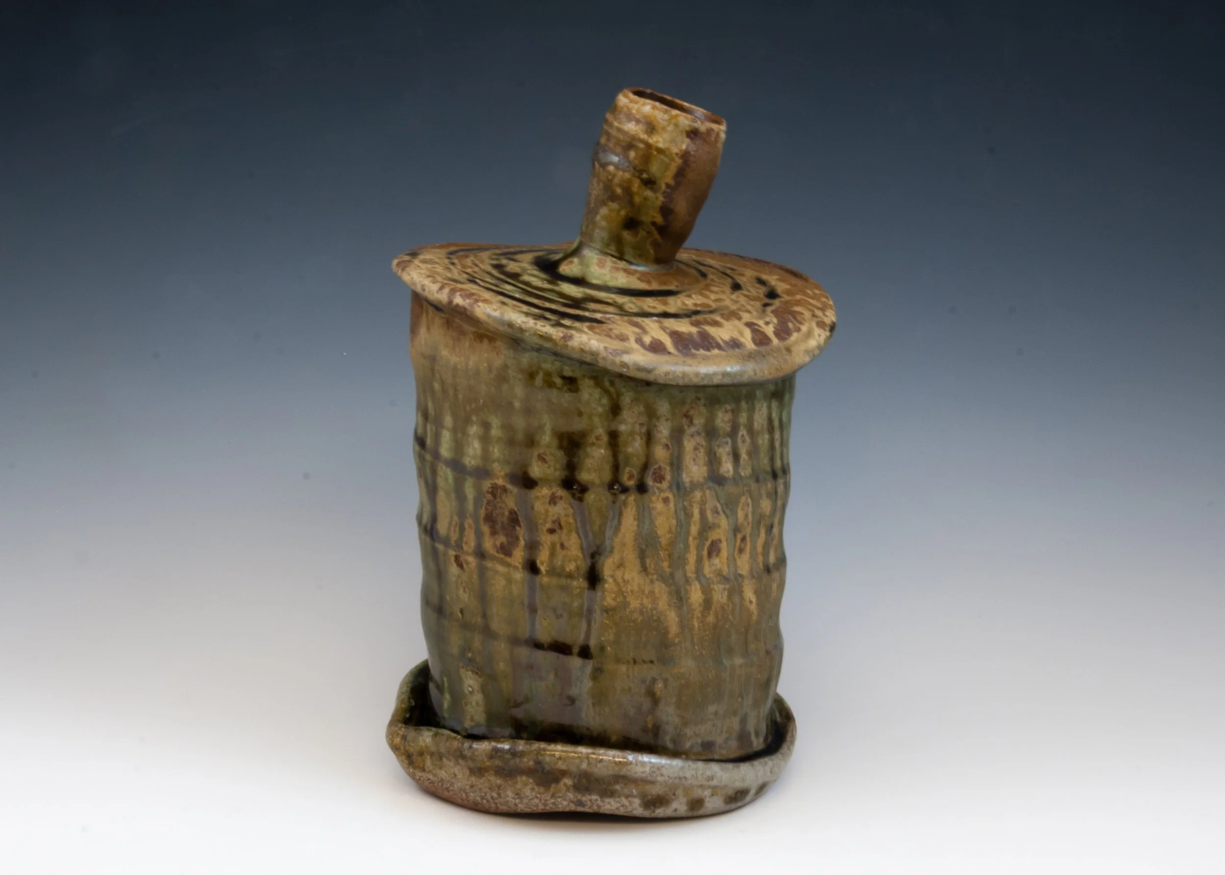 Ancient ceramic vessel with a short cylindrical neck and a wide rounded body, decorated with geometric patterns.