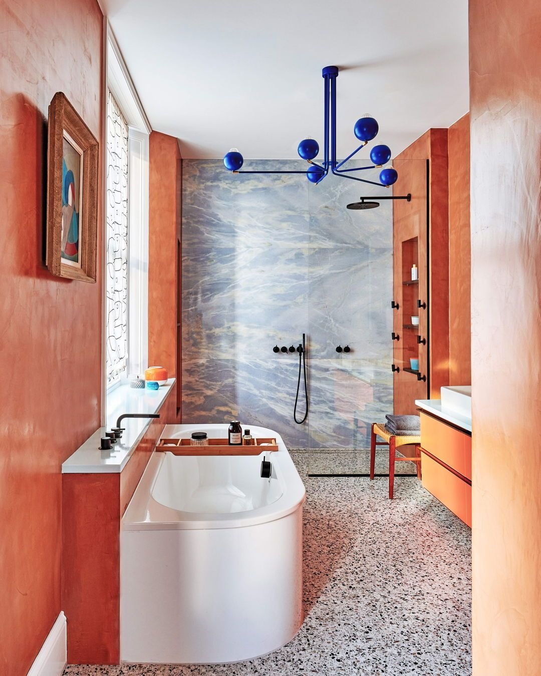 Crafting homes with balance, warmth, refinement, and individuality is our expertise. 

In this project, two bathrooms were transformed with terracotta micro-cement and sky-blue marble walls, creating a mid-century Moroccan 'house of glam' ambience. O
