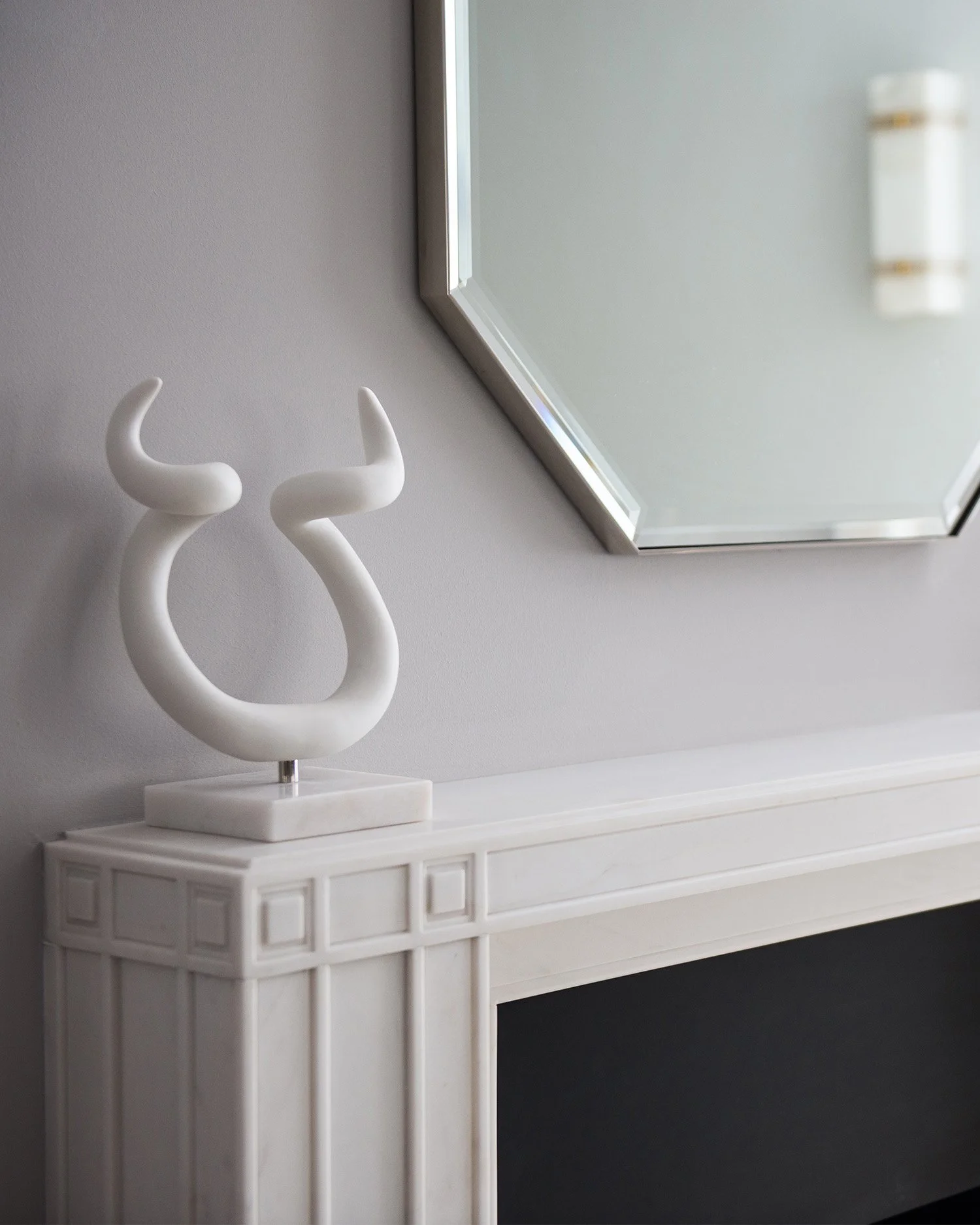 We were inspired by the deco detailing in the joinery to design this unstated but luxurious marble fireplace - a nod to Mackintosh. To accompany it, we made a bespoke mirror to sit above the fireplace, made of enamel with a subtle corn flower blue in