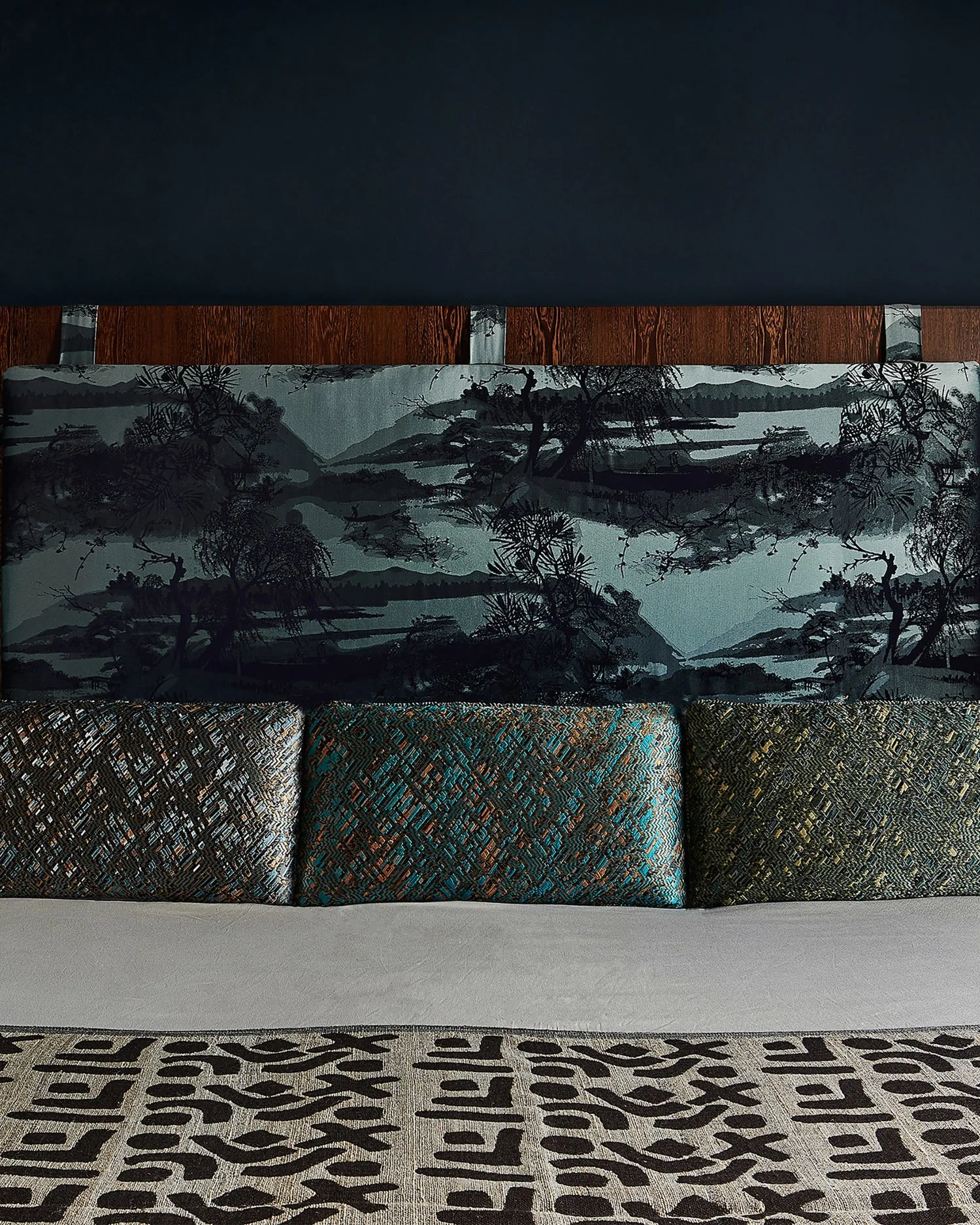 For the principal bedroom in this Notting Hill house we used some of the remaining timber from the dining room to create the headboard on which we decided to hang a printed panoramic, the fabric is a beautiful forest mountain scene. As the bed is hig