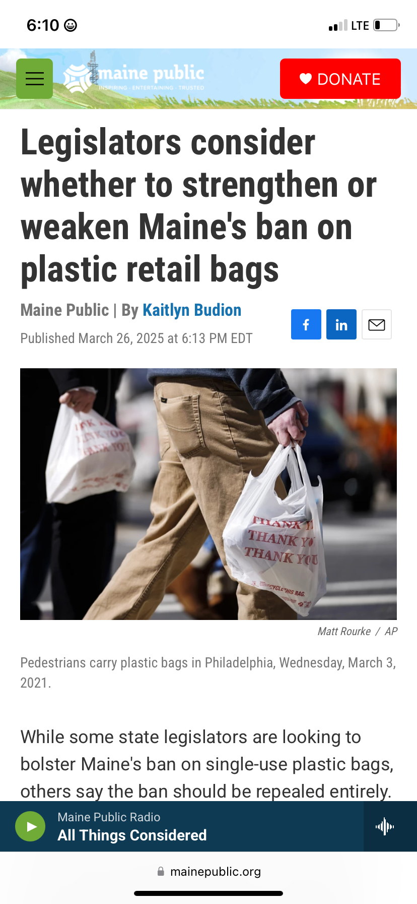 Pedestrians walking in Philadelphia on March 3, 2021, carrying plastic shopping bags with red text that says "Thank You."