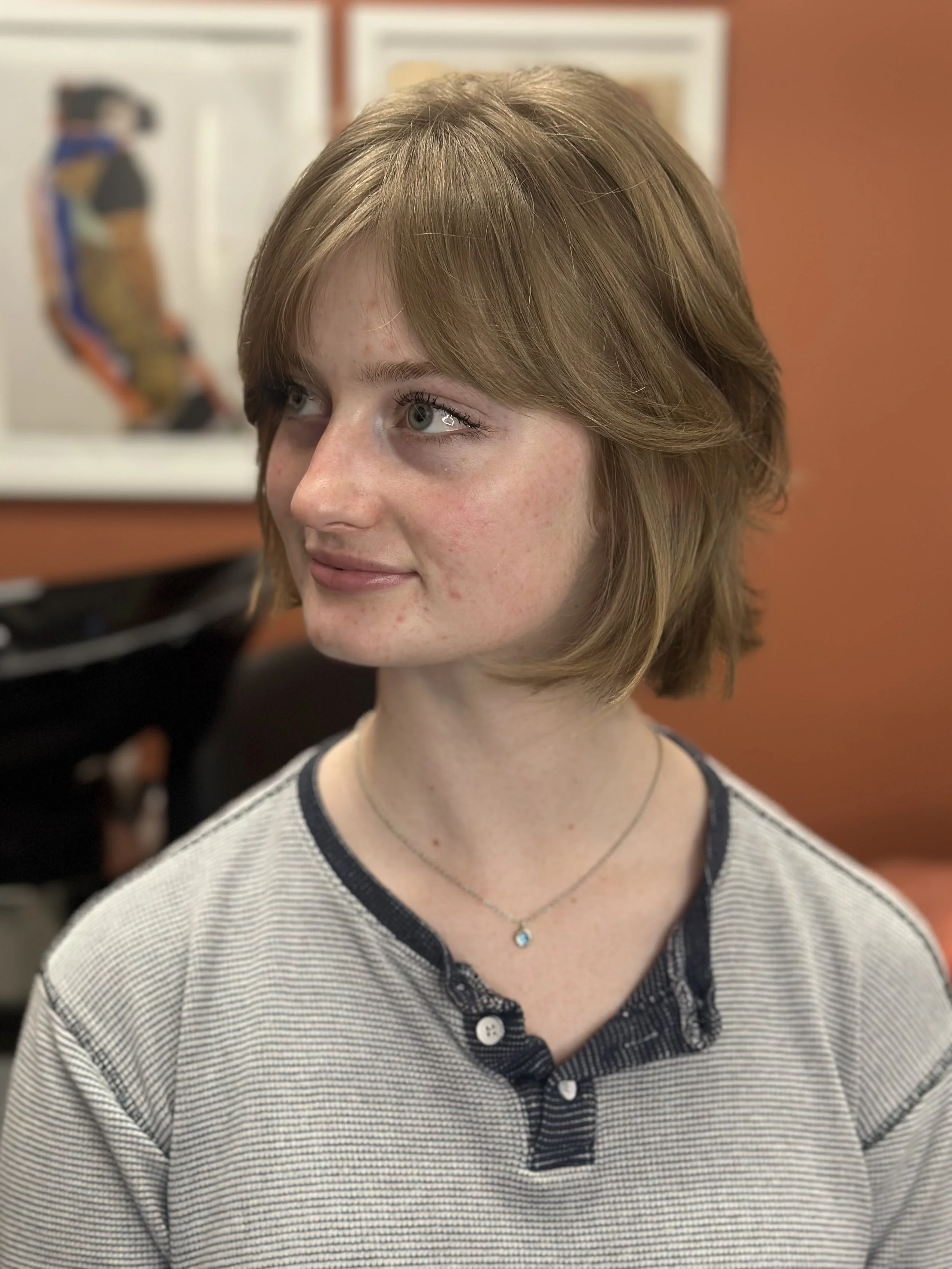 Short layered haircut on lightly wavy hair texture and medium density.