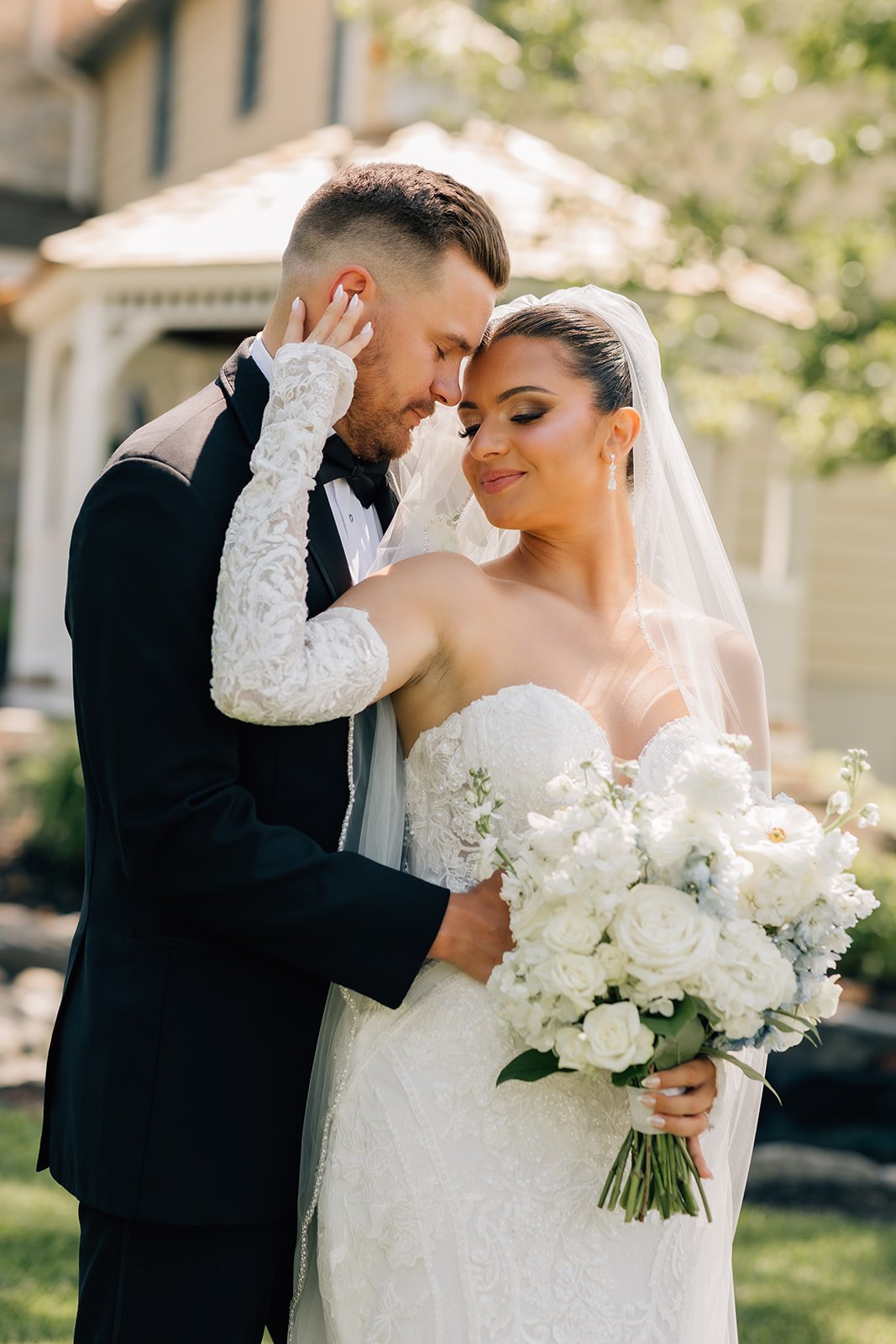 Cathedral veil. Black tux. A lush, timeless elegant wedding bouquet of white roses, hydrangea, stock, and delicate hints of blue.